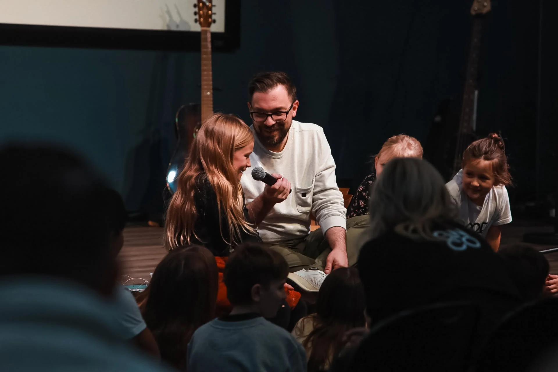 A church leader connecting with children at Good News Co.