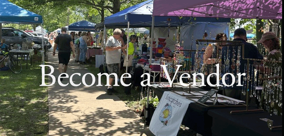 Outdoor market with multiple vendor booths under tents, shoppers browsing, and trees providing shade, with a pathway in the center.