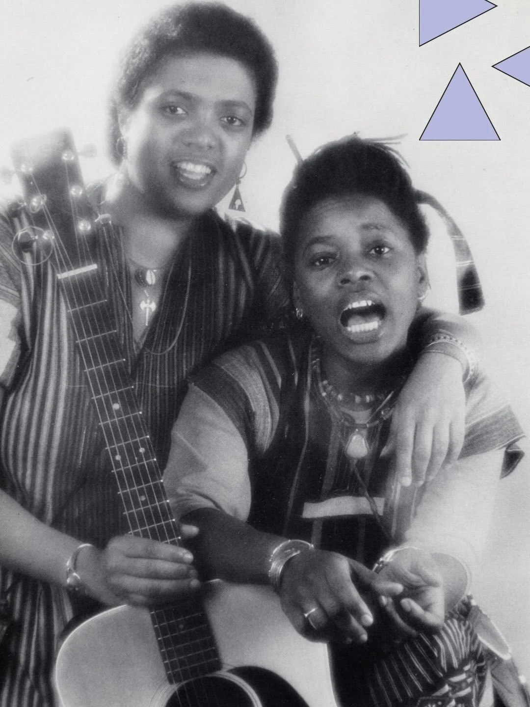 A promotional photo for the reggae, folk band Casselberry-Dupre&eacute;, with band members Judith Casselberry and Jaque Dupre&eacute;, sitting with a guitar in front of them.

Lesbians Jaque Dupre&eacute; and J Castleberry formed the band Castleberry