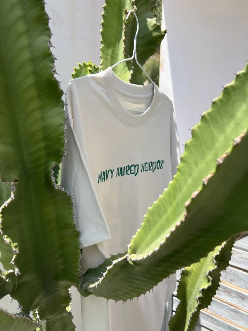 Embrace your inner beach bum wizard with the Wavy Haired Weirdos Surf Tee, the ultimate symbol of seaside freedom and tranquility.