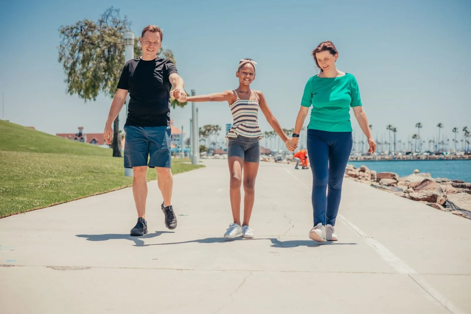family walking in sunny street heading to adoption therapy for birth families
