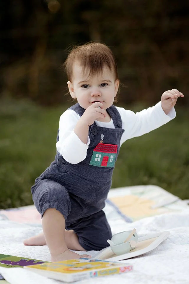 One year old trying to stand up during a photoshoot.
