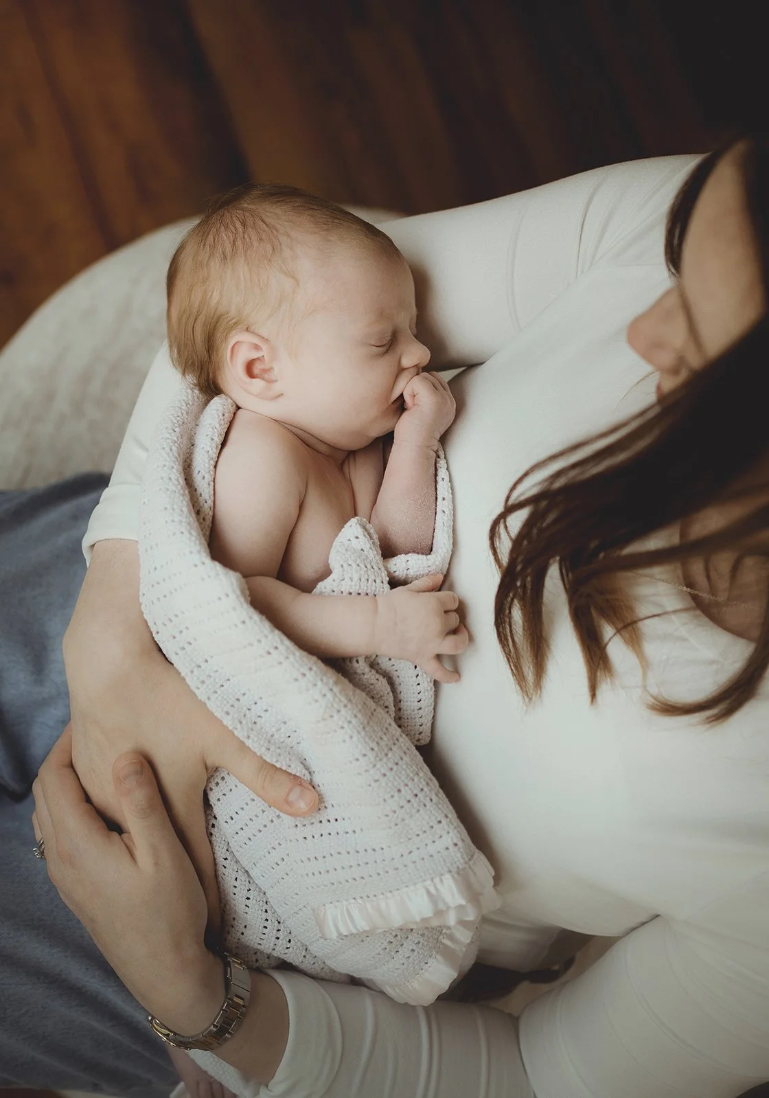 Mother holding her sleeping newborn baby during a calm lifestyle photoshoot near Bath.