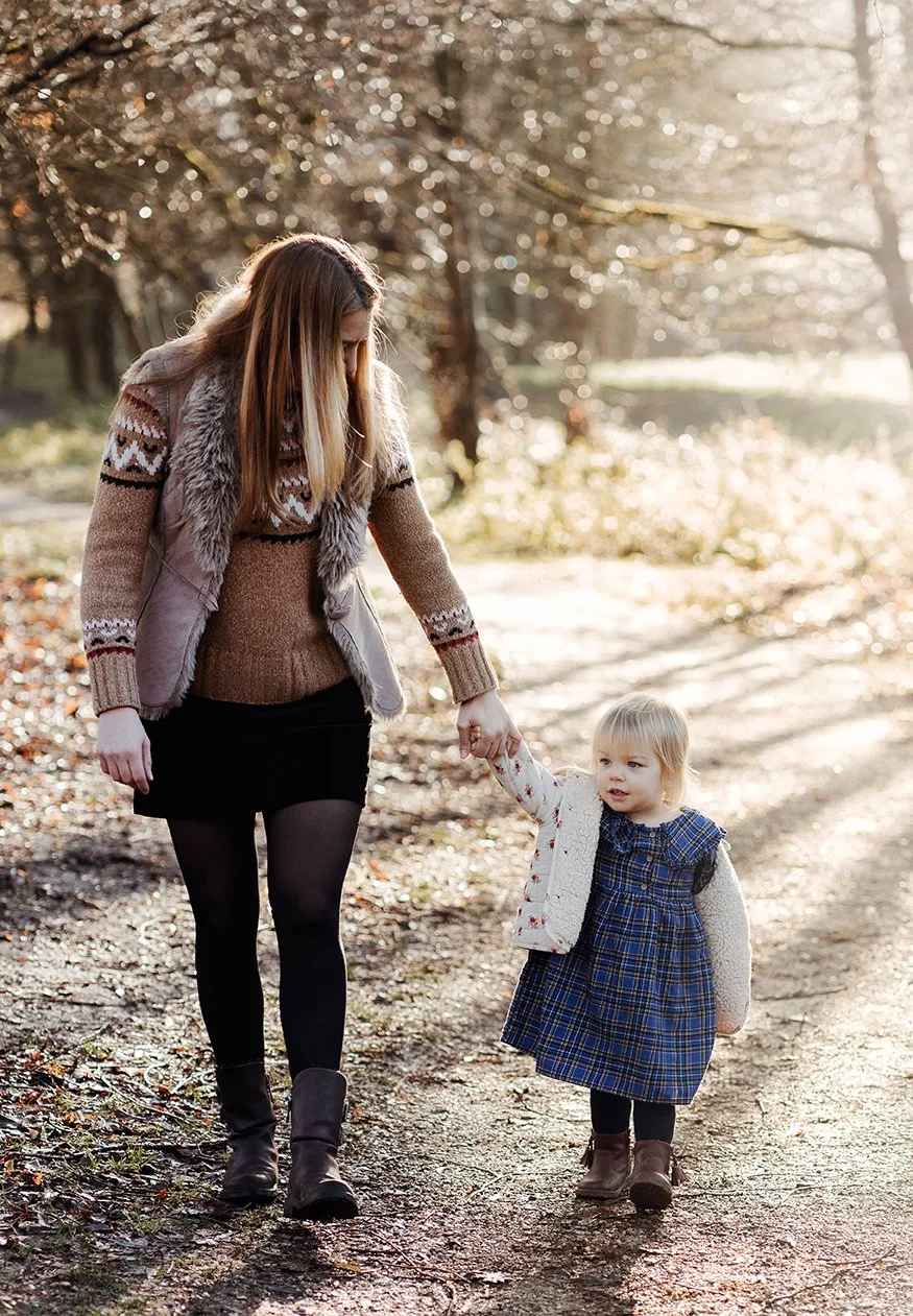 Mum and daughter holding hands during a family photoshoot in Bath