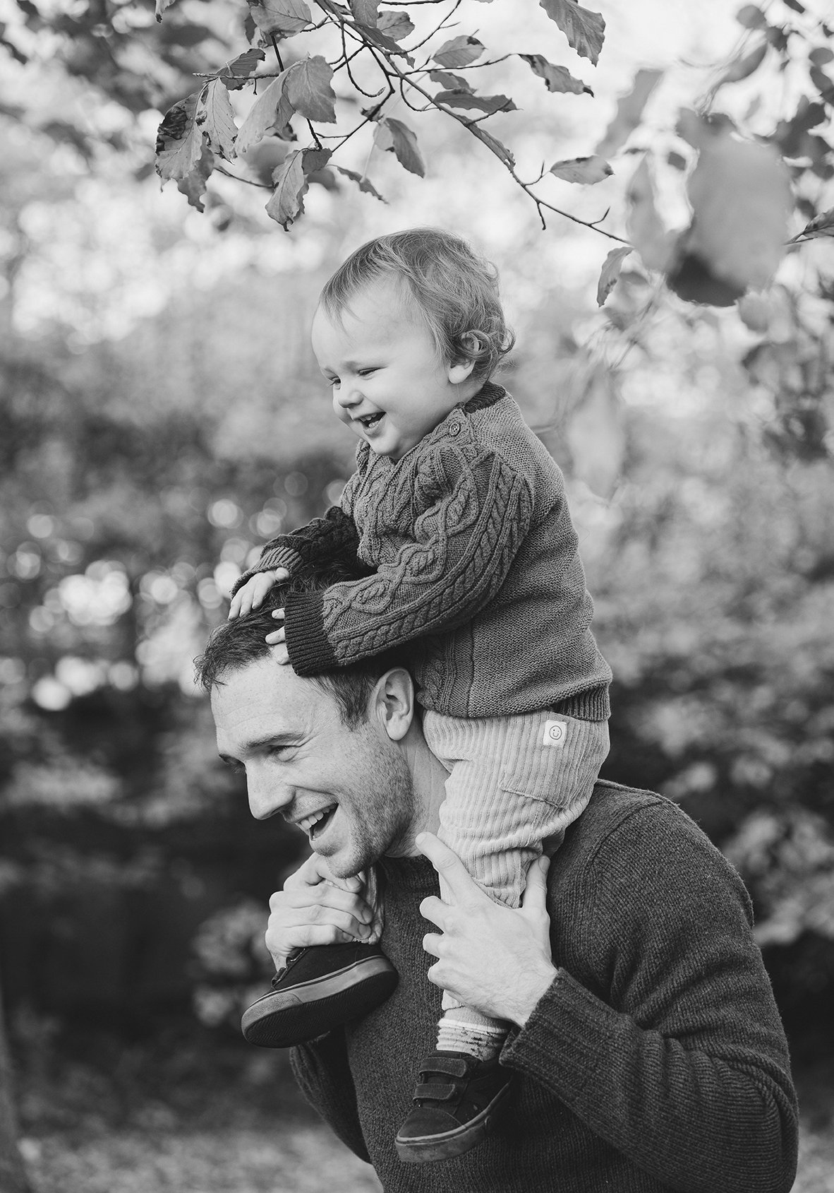 Little boy on his father's shoulders during an outdoor family photoshoot in Bristol.