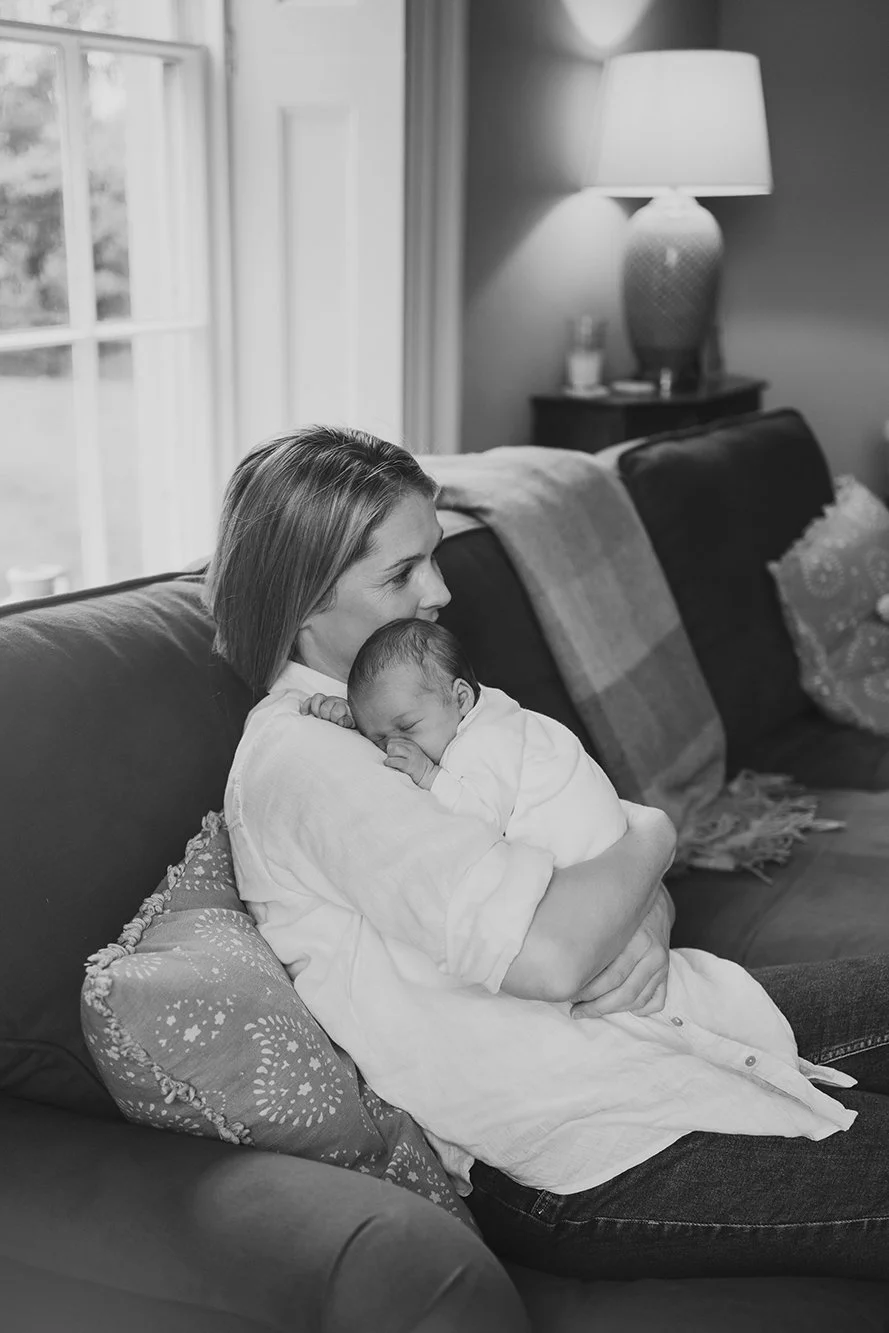 Mother holding her baby during a photoshoot - black and white picture