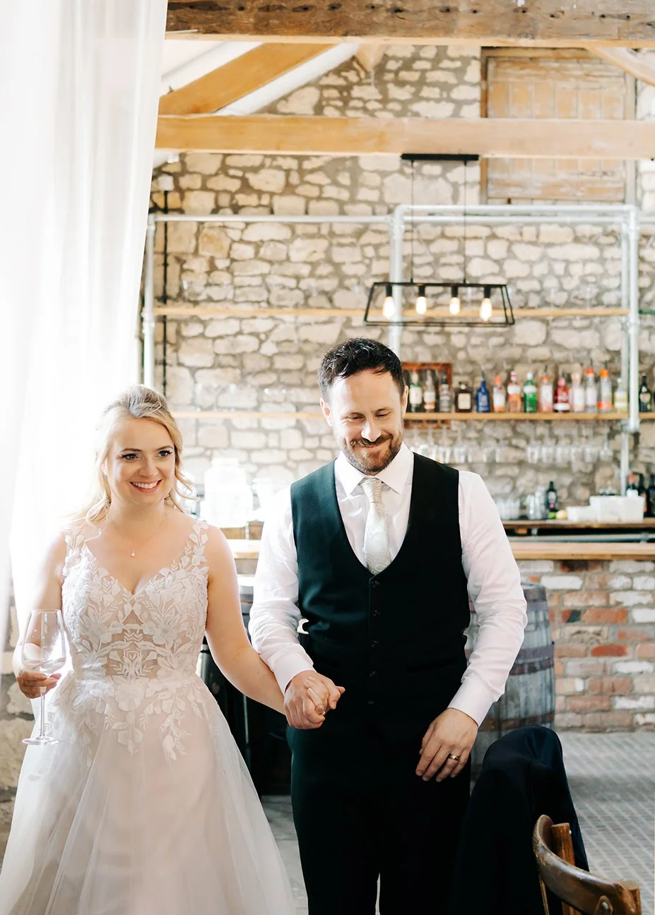 Image of the wedding couple walking into The Barn.