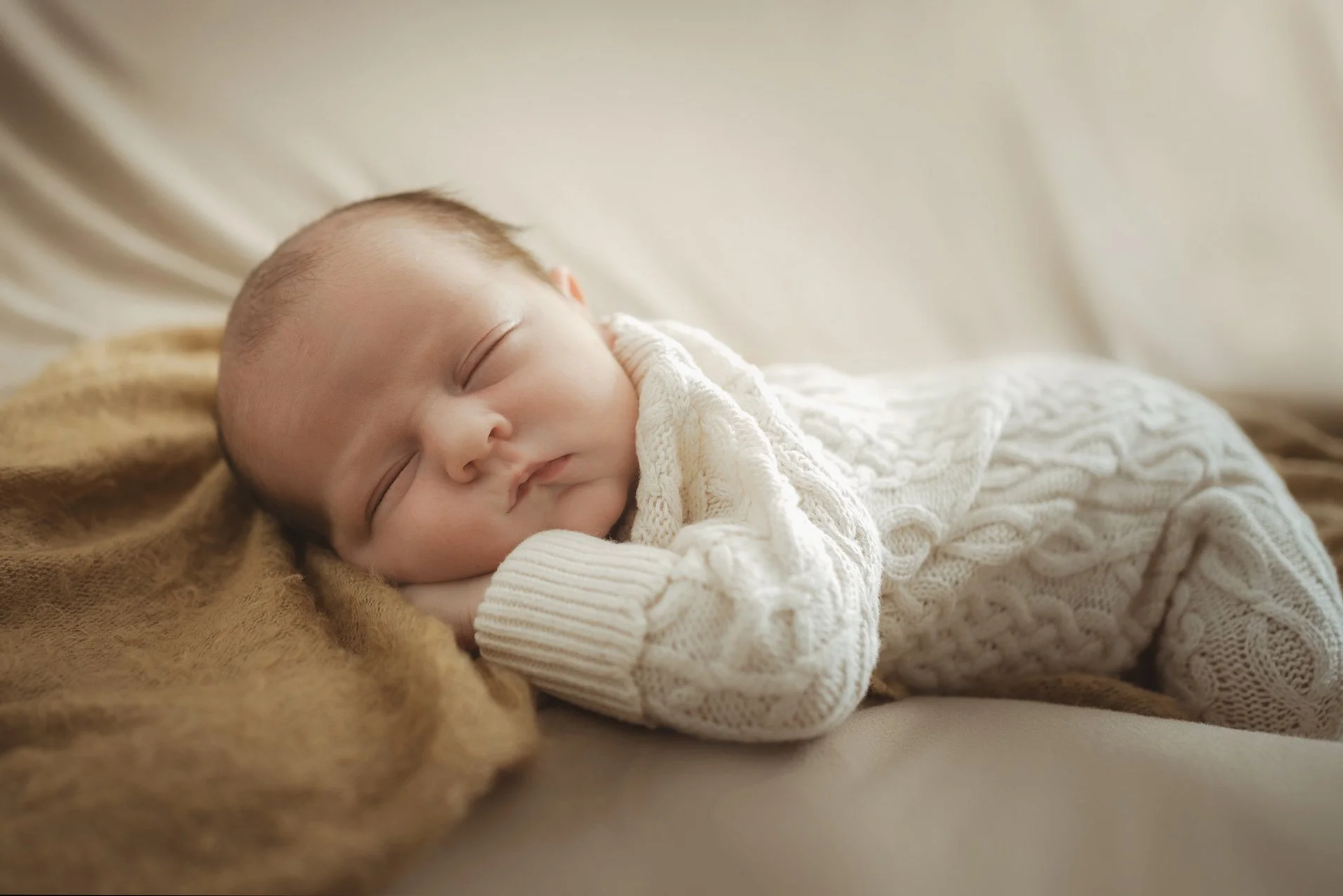Newborn and baby photographer in Bristol - image of a newborn baby sleeping during a photoshoot.