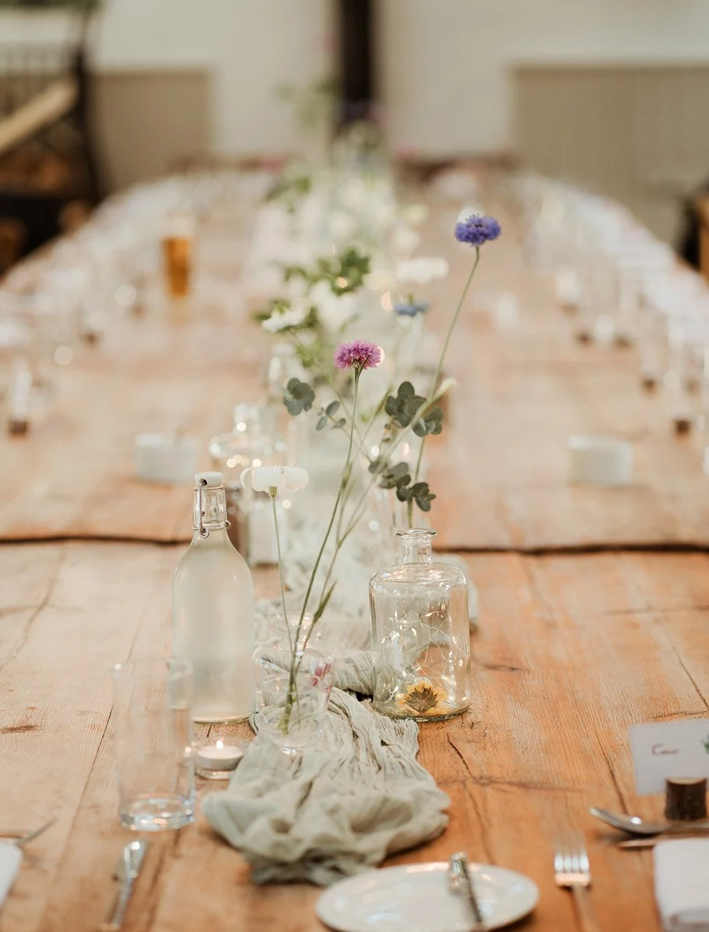 Bristol wedding photographer - image of flowers and a table set for the wedding breakfast at Old Down Estate, near Bristol.