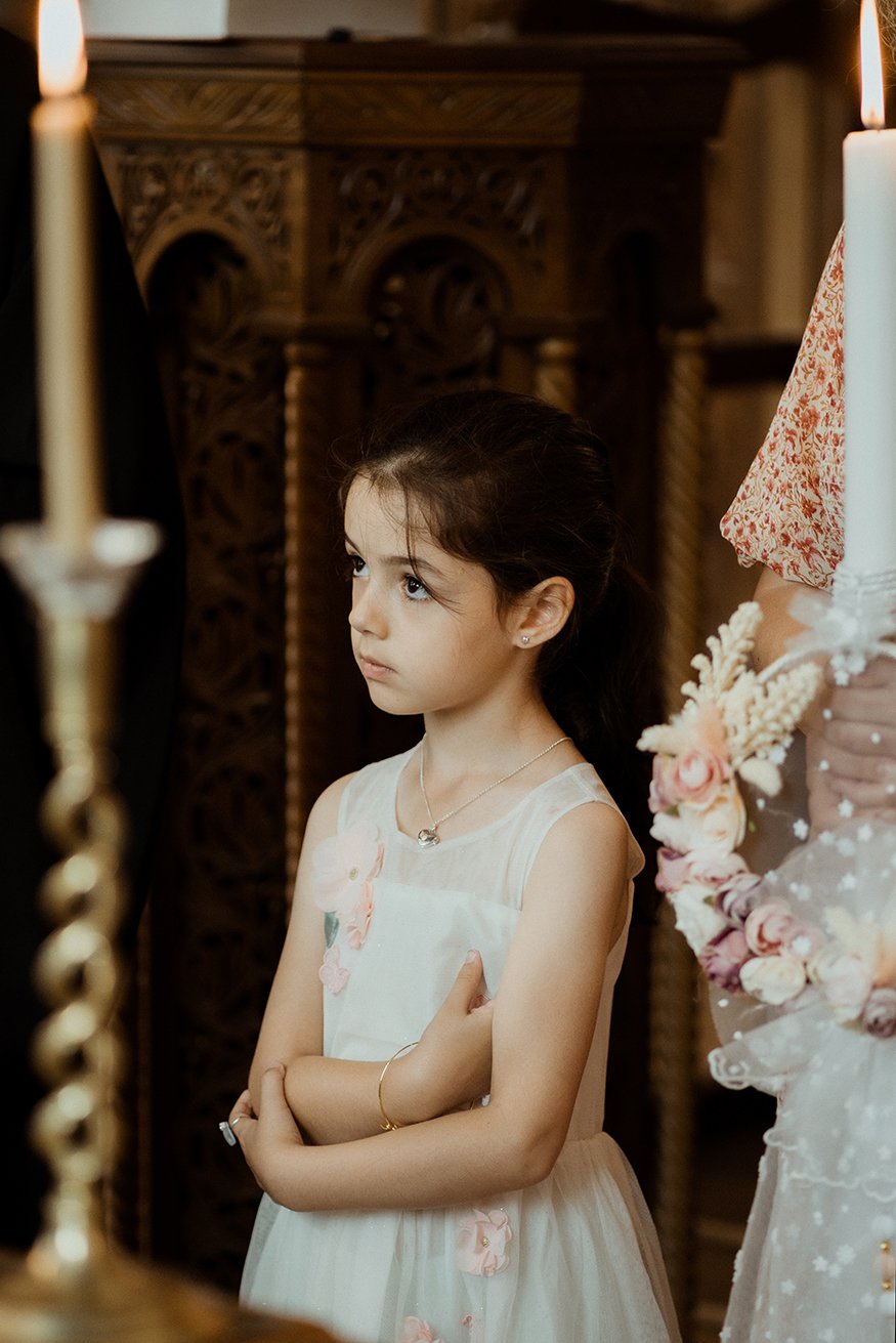 Bristol baptism photographer - image of a girl watching the baptism