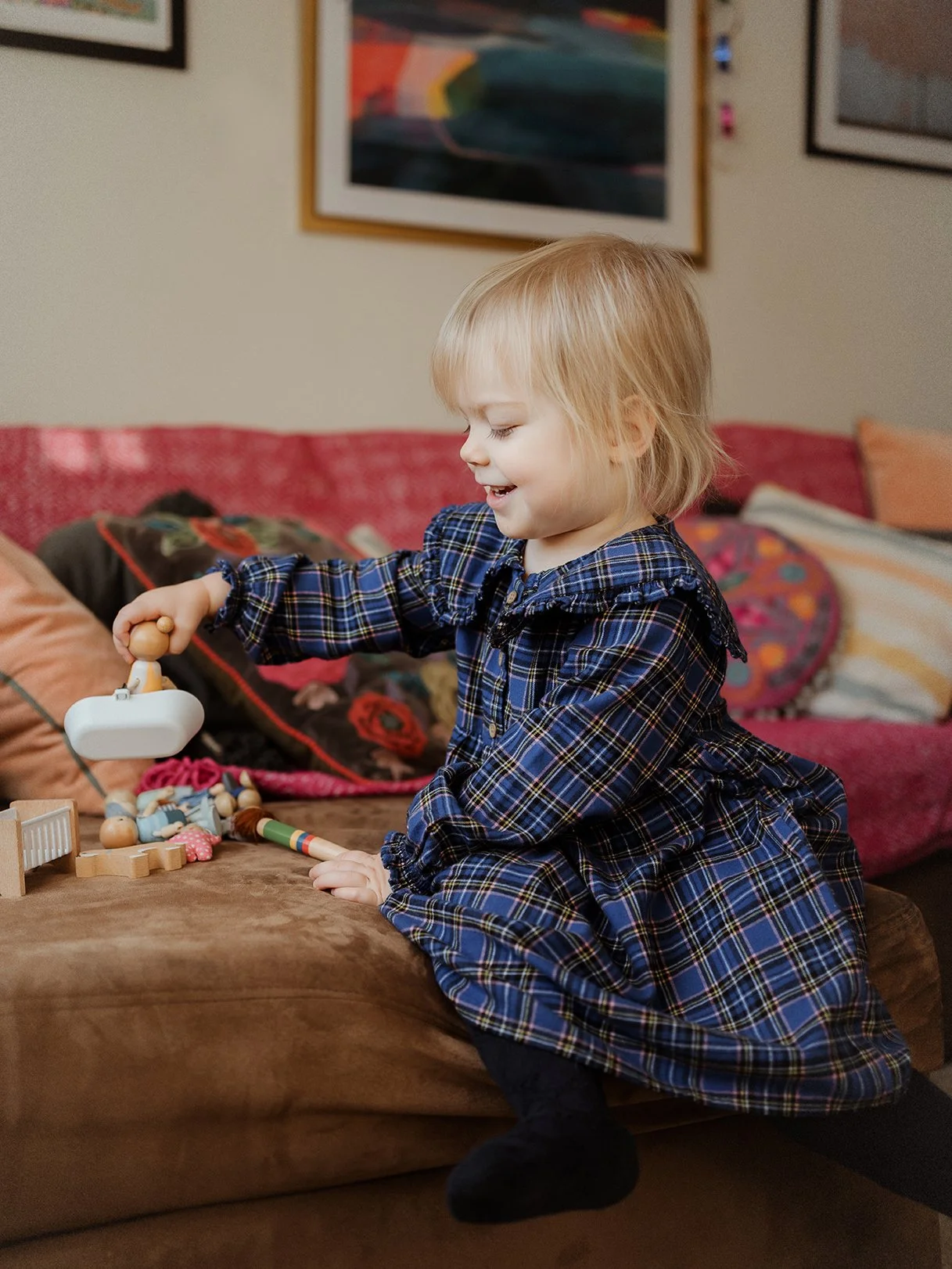 Little girl playing with her little wooden toys during a photoshoot in Bath
