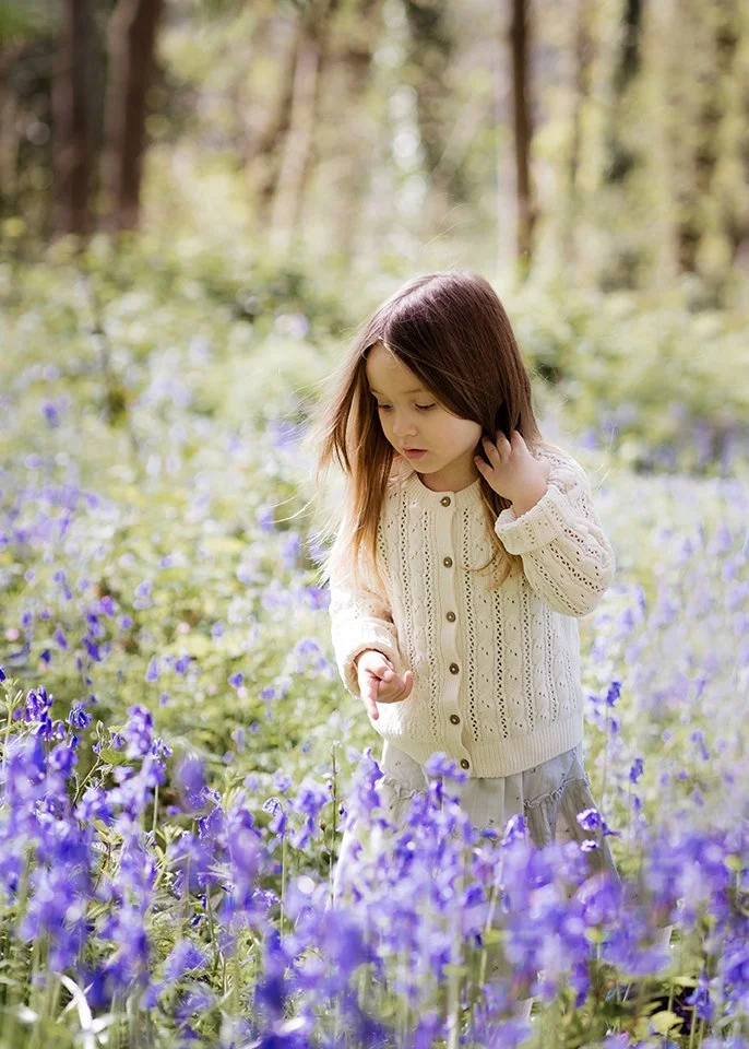 Bristol family photographer - image of a little girl walking through bluebells