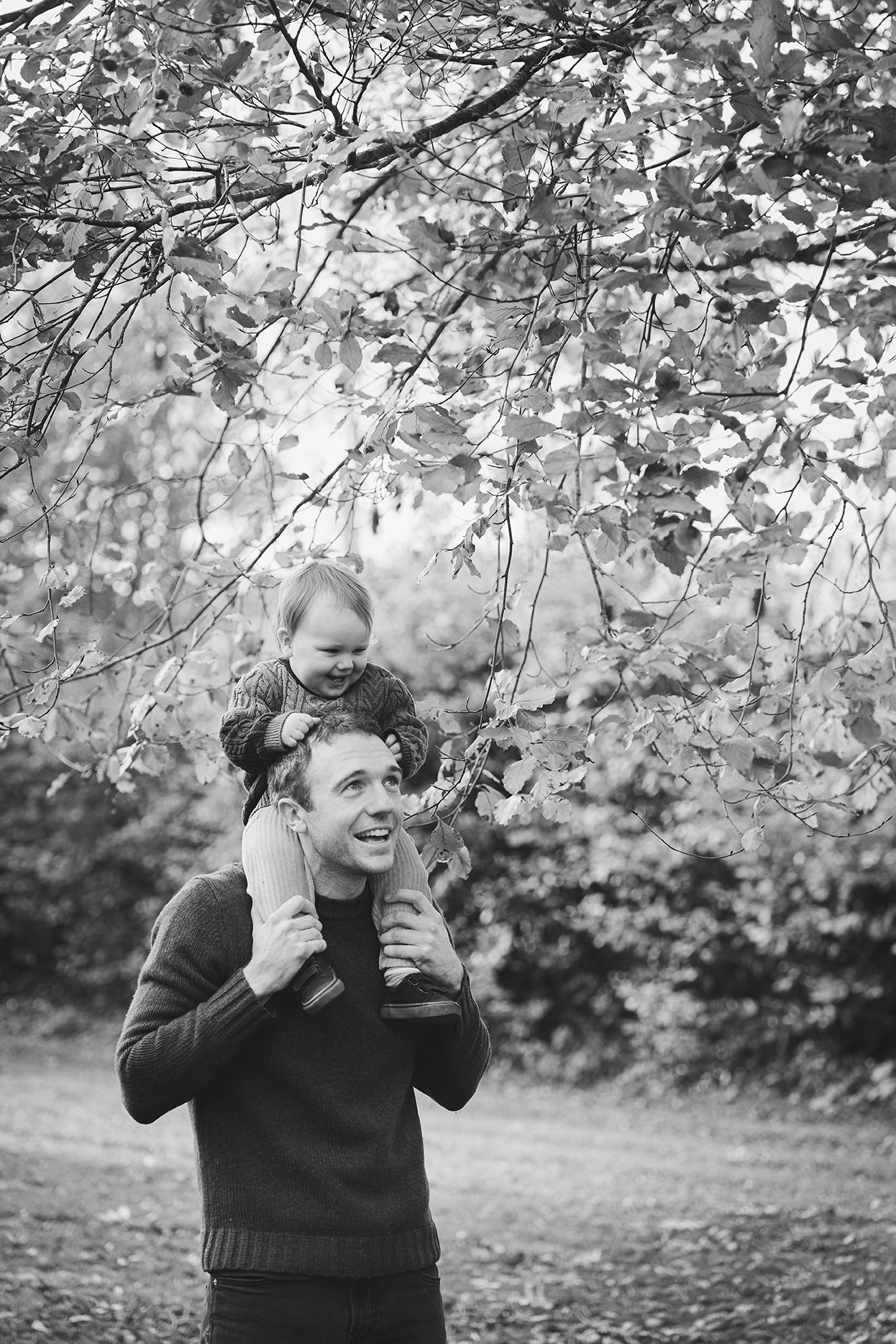 Little boy on his father's shoulders during an outdoor family photoshoot in Bristol.