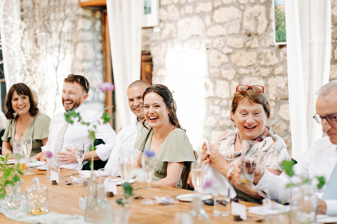 Image of guests laughing at speech.