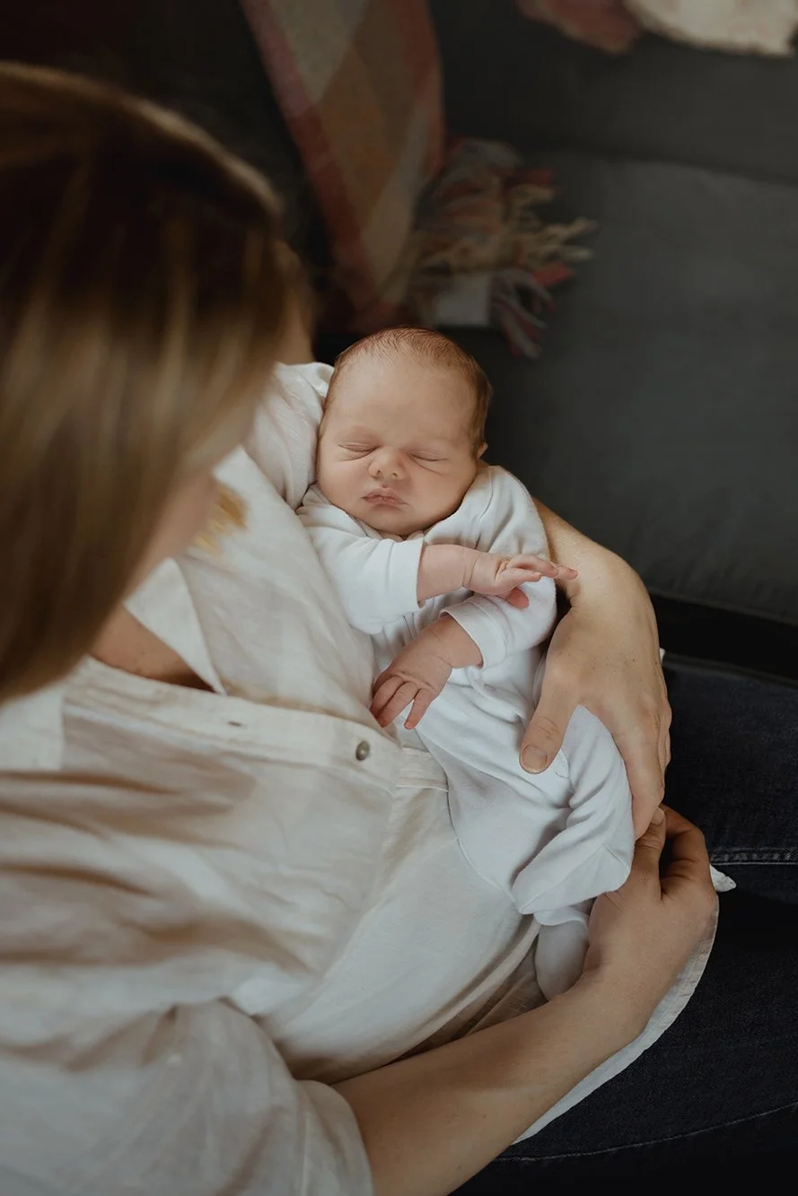 Mother holding her baby during a photoshoot.