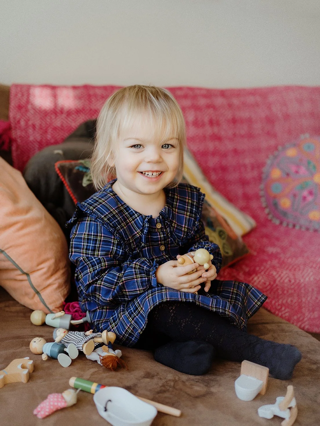 Little girl smiling at camera during a photoshoot in Bath