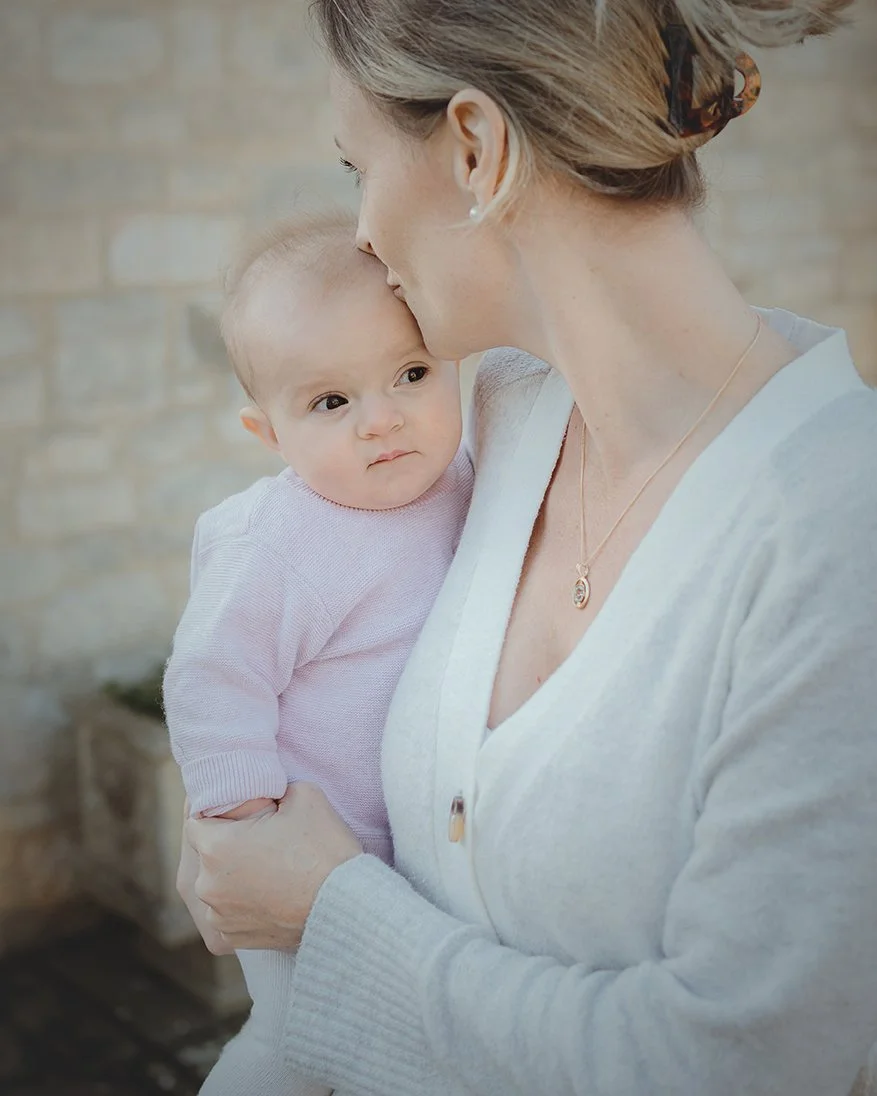 Image of mother with baby daughter during a family photoshoot.