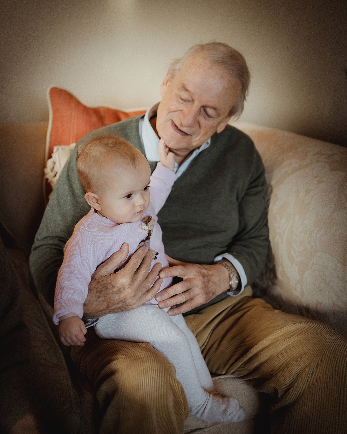 Image of grandfather with grandaughter during a family photoshoot.