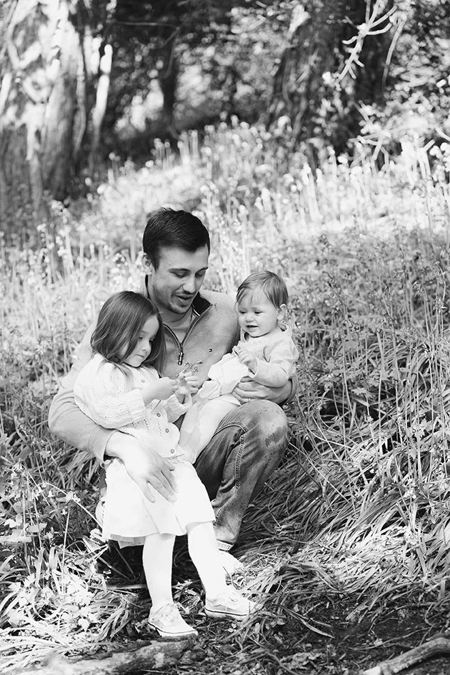 Bristol family photographer - image of a father with his two daughters.