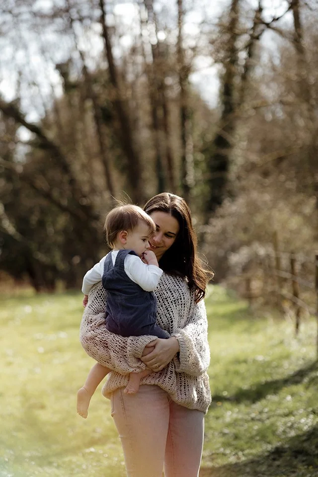 Mother carrying her little boy during a family photoshoot.