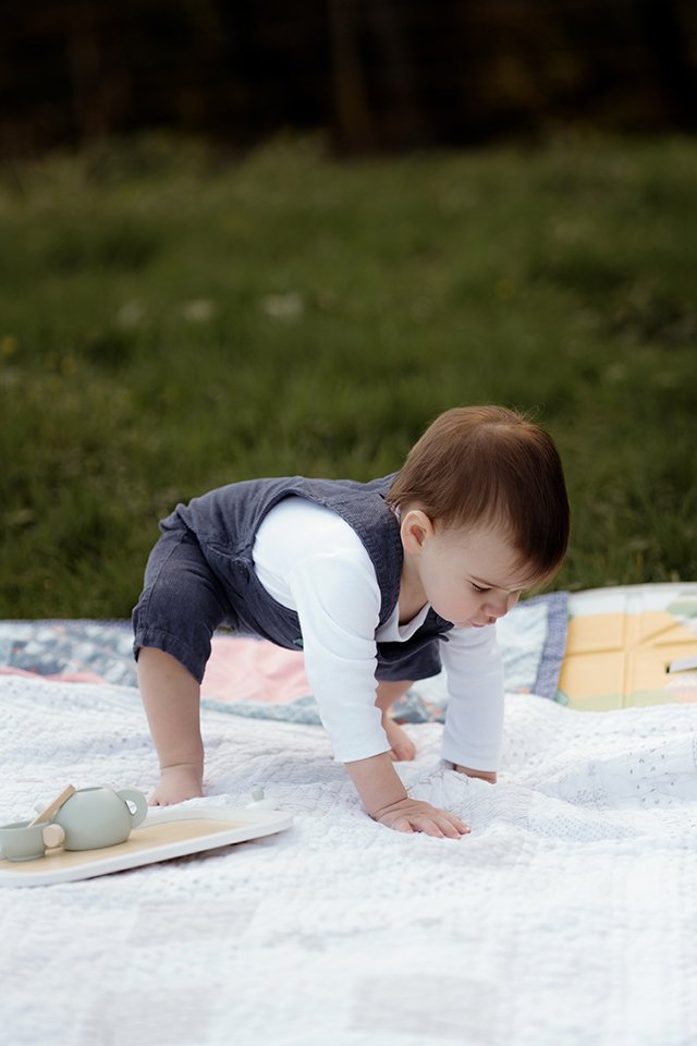One year old trying to stand up during a photoshoot.