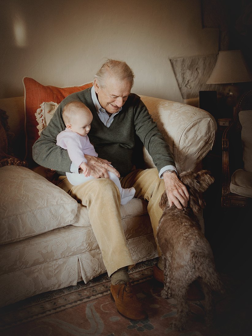 Image of grandfather with grandaughter during a family photoshoot.