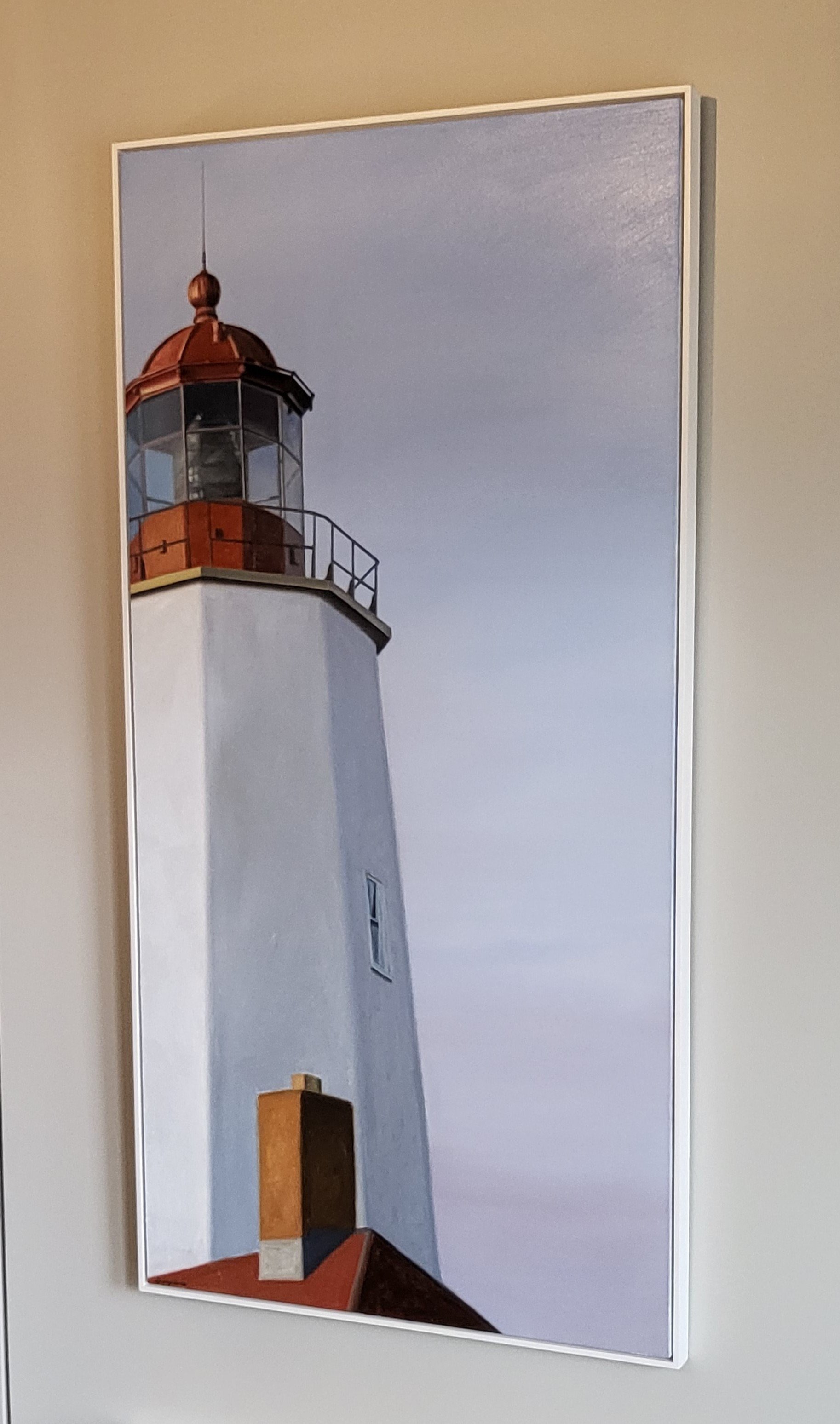 Photograph of a lighthouse against a cloudy sky, viewed from below.