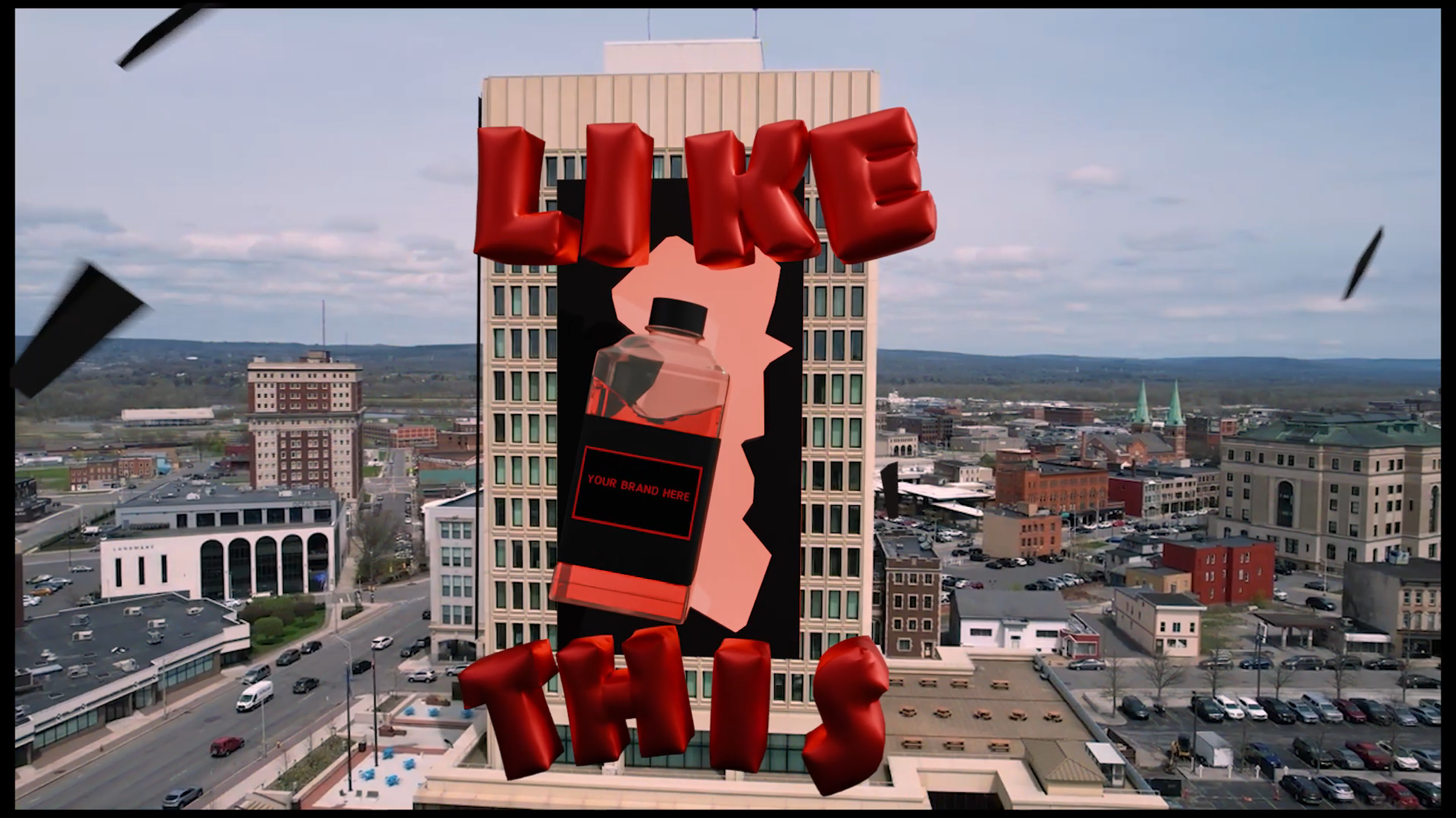 A digital billboard on a city building displaying an advertisement for liquor with the word 'LIKE' in large red 3D letters at the top and 'T' at the bottom, with a bottle of liquor in the center, in a city with texts and buildings in the background.