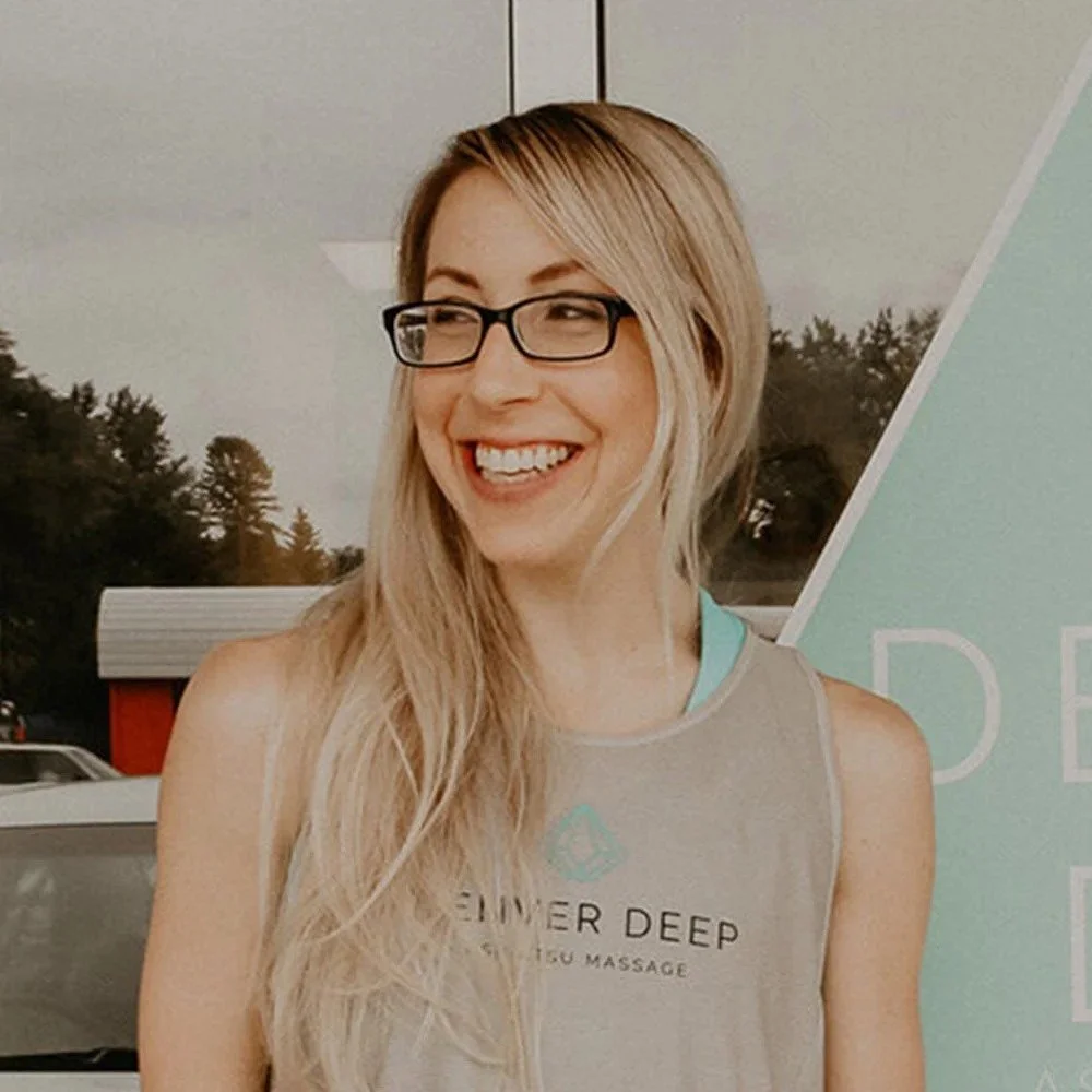 Patty Blake is a Six Leaf Design client and owner of Denver Deep Ashiatsu Massage. She is a young woman with glasses and long blonde hair smiling, wearing a tank top from Deep Recovery massage.