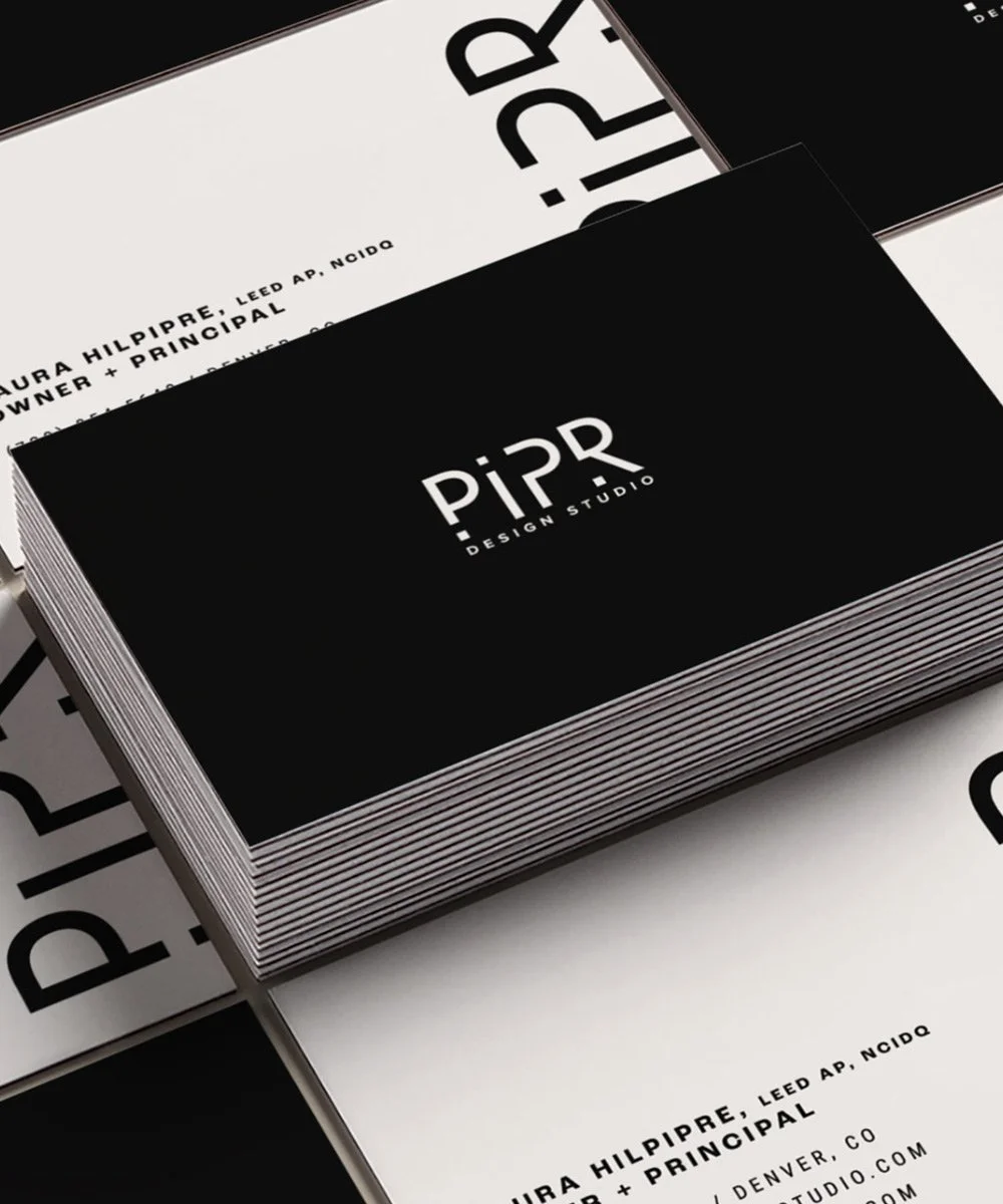 Stack of black and white business card designs with the logo 'PiPR Design Studio'