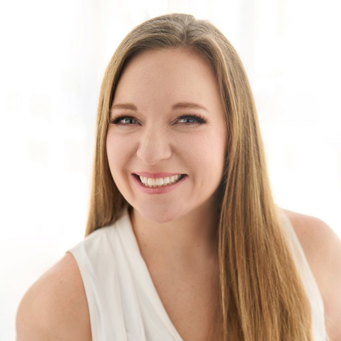 Jenny Reynolds is a Six Leaf Design client and owner of Graceful Guidance Elder Care. She is a young woman with long light brown hair smiling at the camera, wearing a sleeveless white top, in front of a bright, softly lit background.