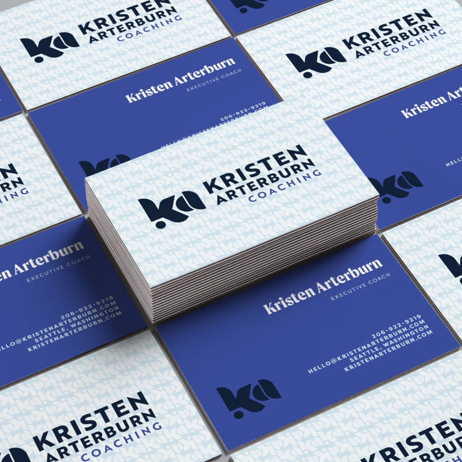 Business card design for Kristen Arterburn Coaching, with a blue and white color scheme, displaying contact information and logo.