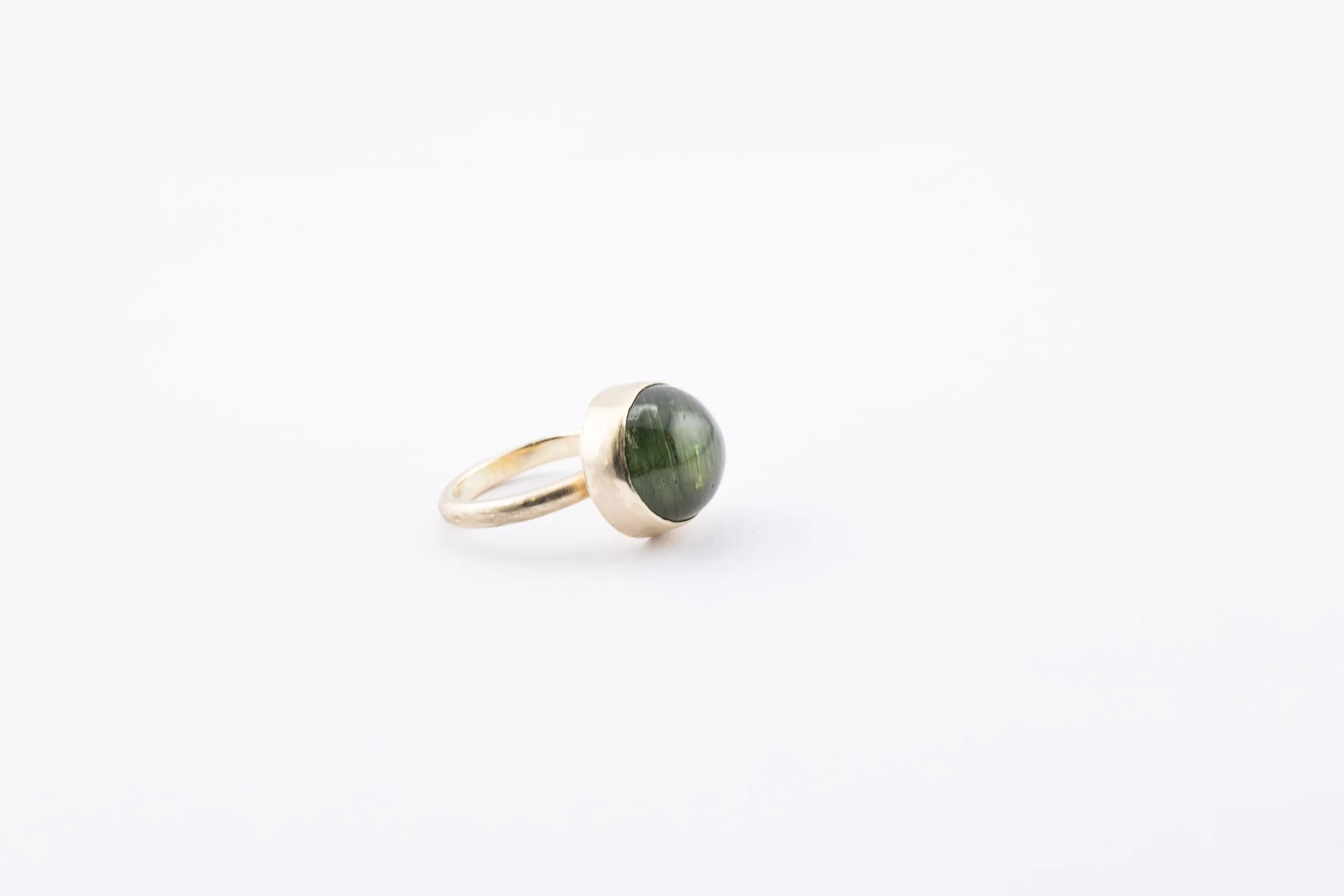 Gold bezel set cat's eye green tourmaline cabochon ring.jpg