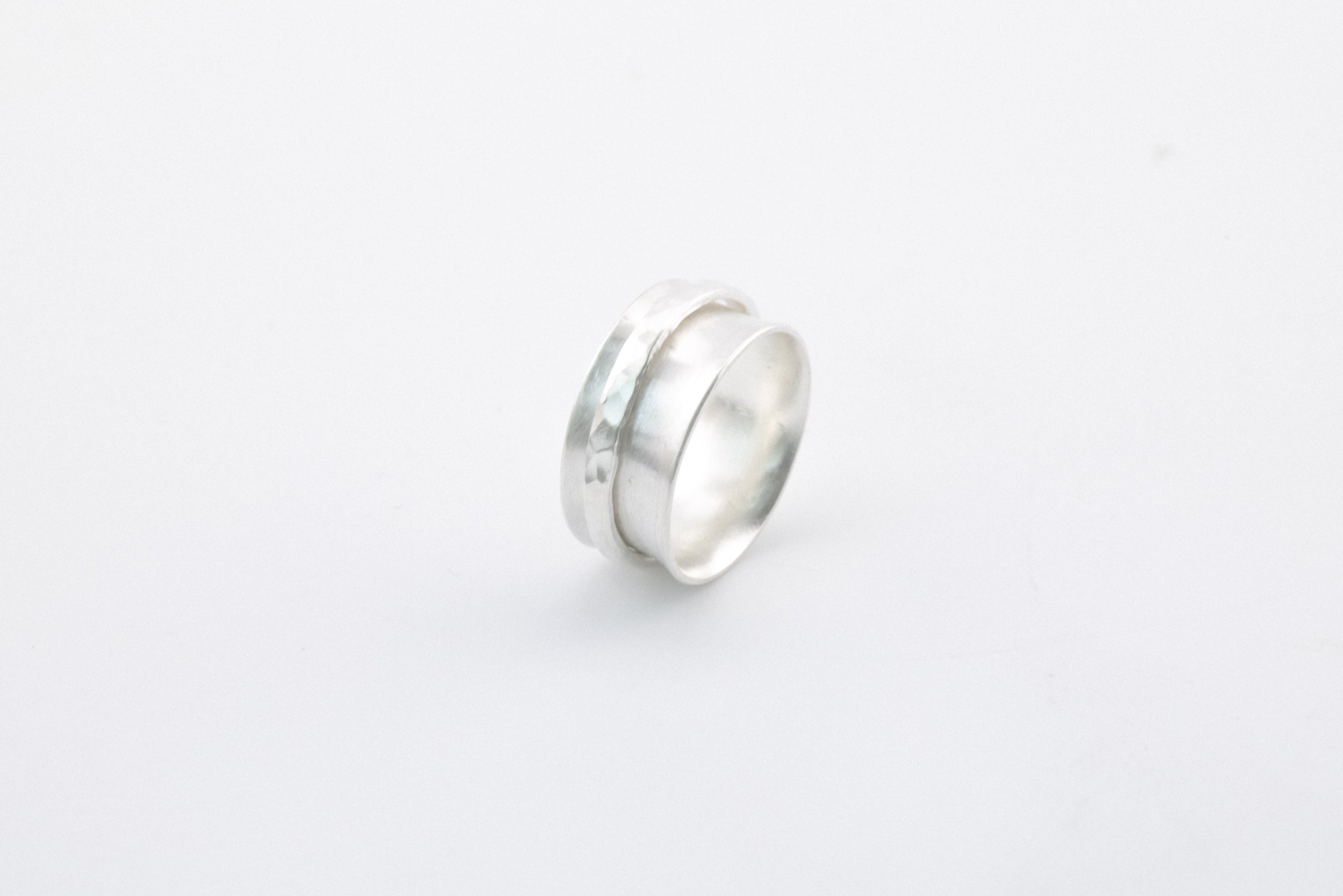 Wide flared silver band with hammered spinner.jpg