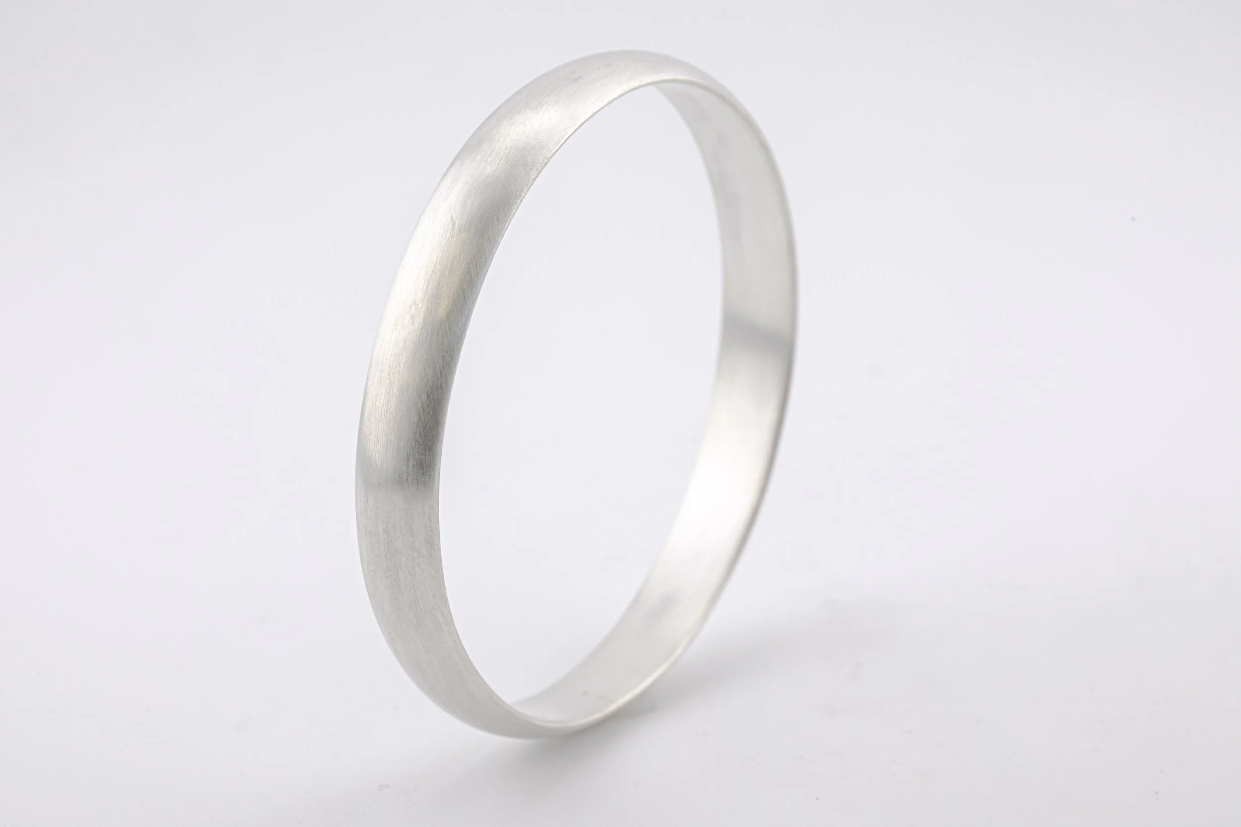 Satin finish bangle in d-shape Sterling Silver upright view.jpg