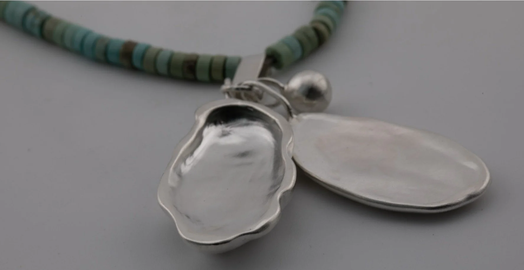Porthilly oyster shell in silver on turquoise beaded chain.jpg