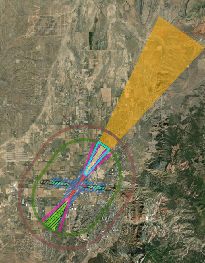 Aerial view of a landscape with a colored overlay of various shapes and lines, likely representing a planned infrastructure or construction project.