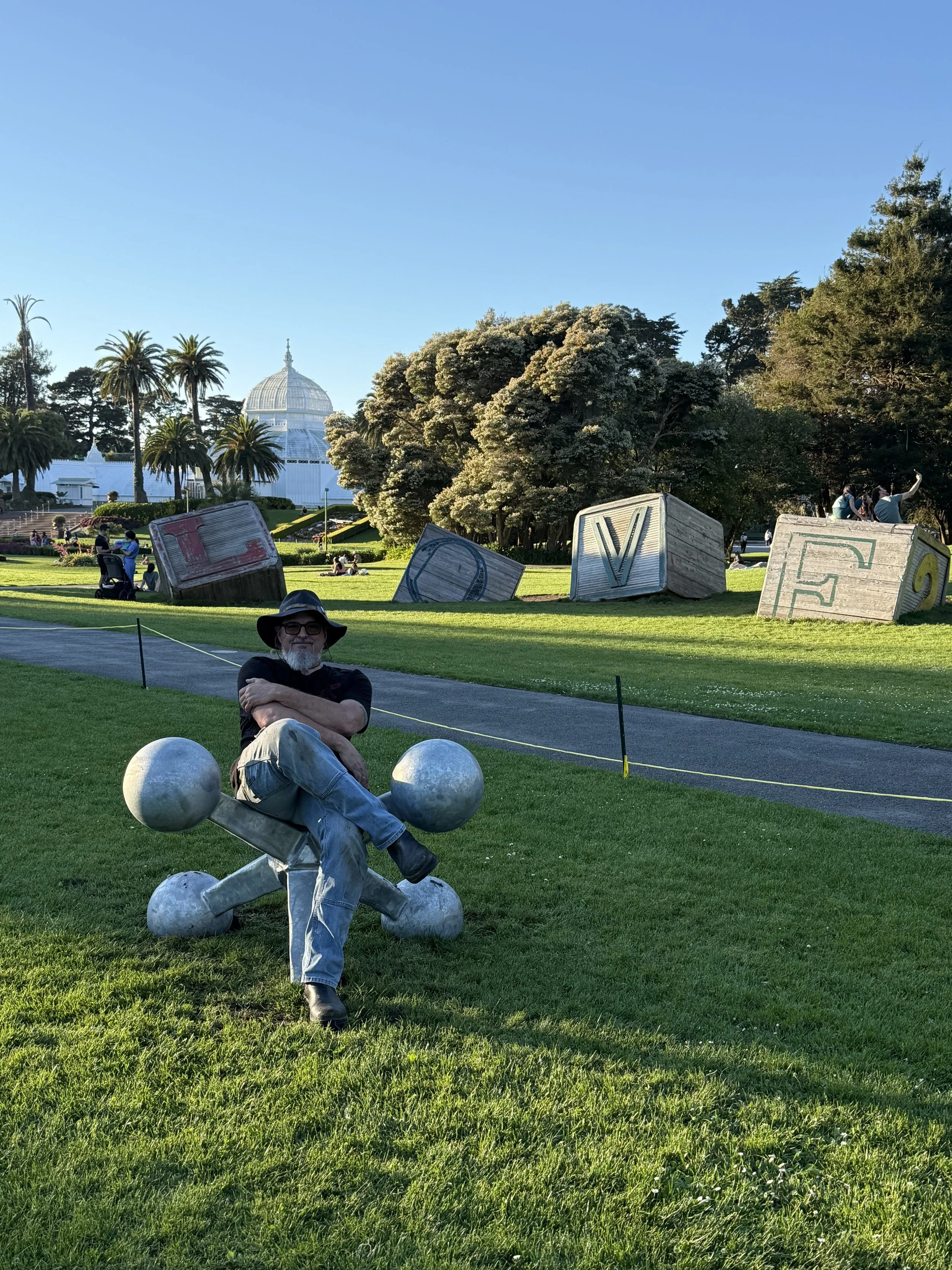 Mark Deem sitting in front of Where's the Ball SF sculpture 