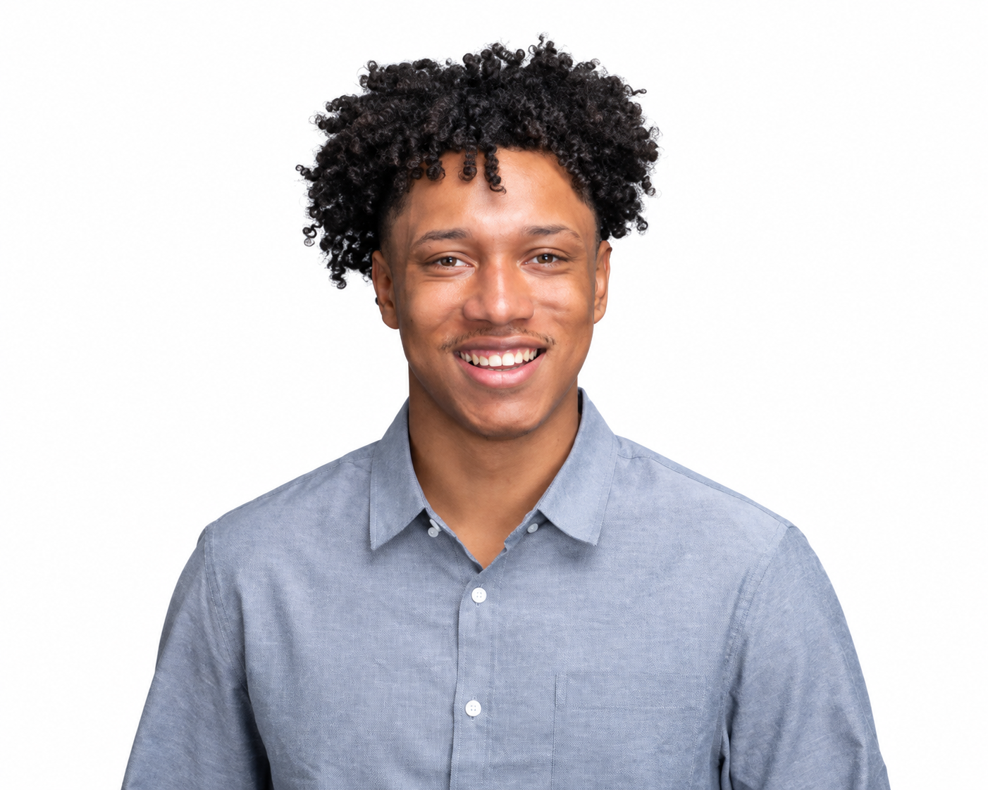 A smiling young man with a gray-blue button up shirt