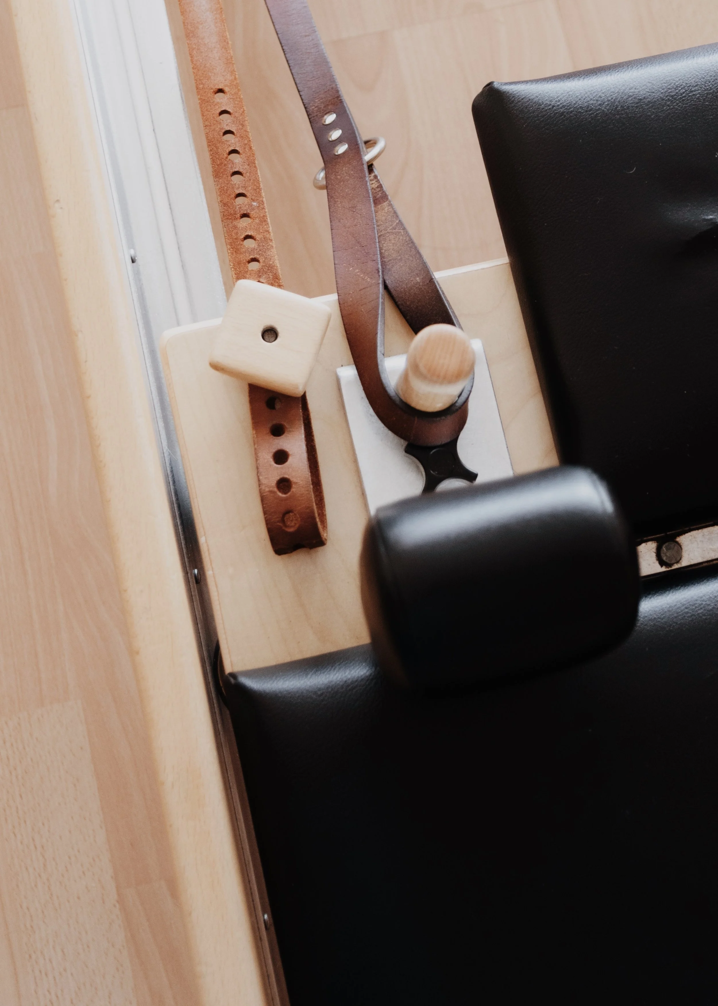 Close-up of a Pilates reformer machine.