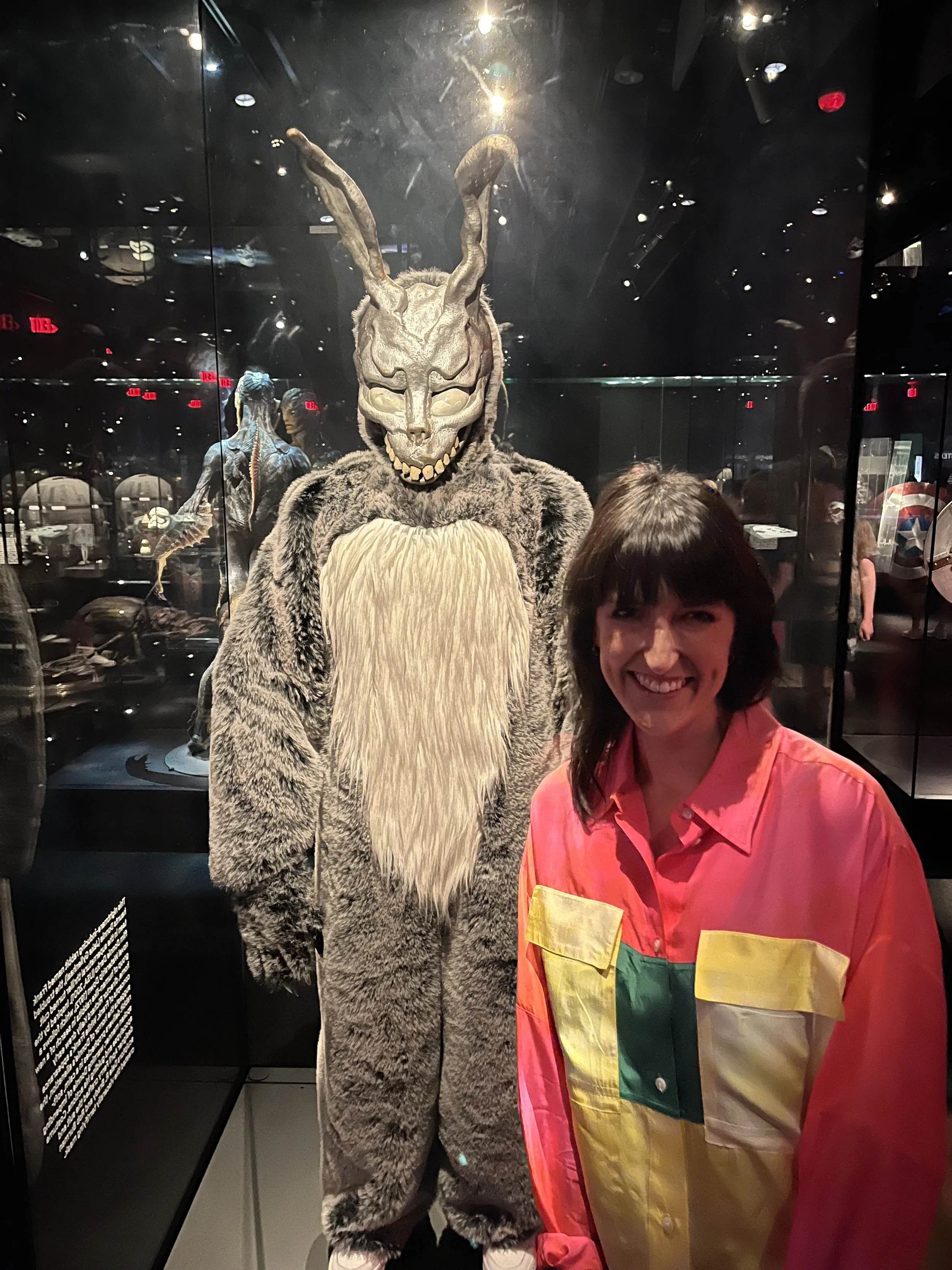 Brittany Feenstra at the Academy Museum of Motion Pictures with the costume of Frank from Donnie Darko