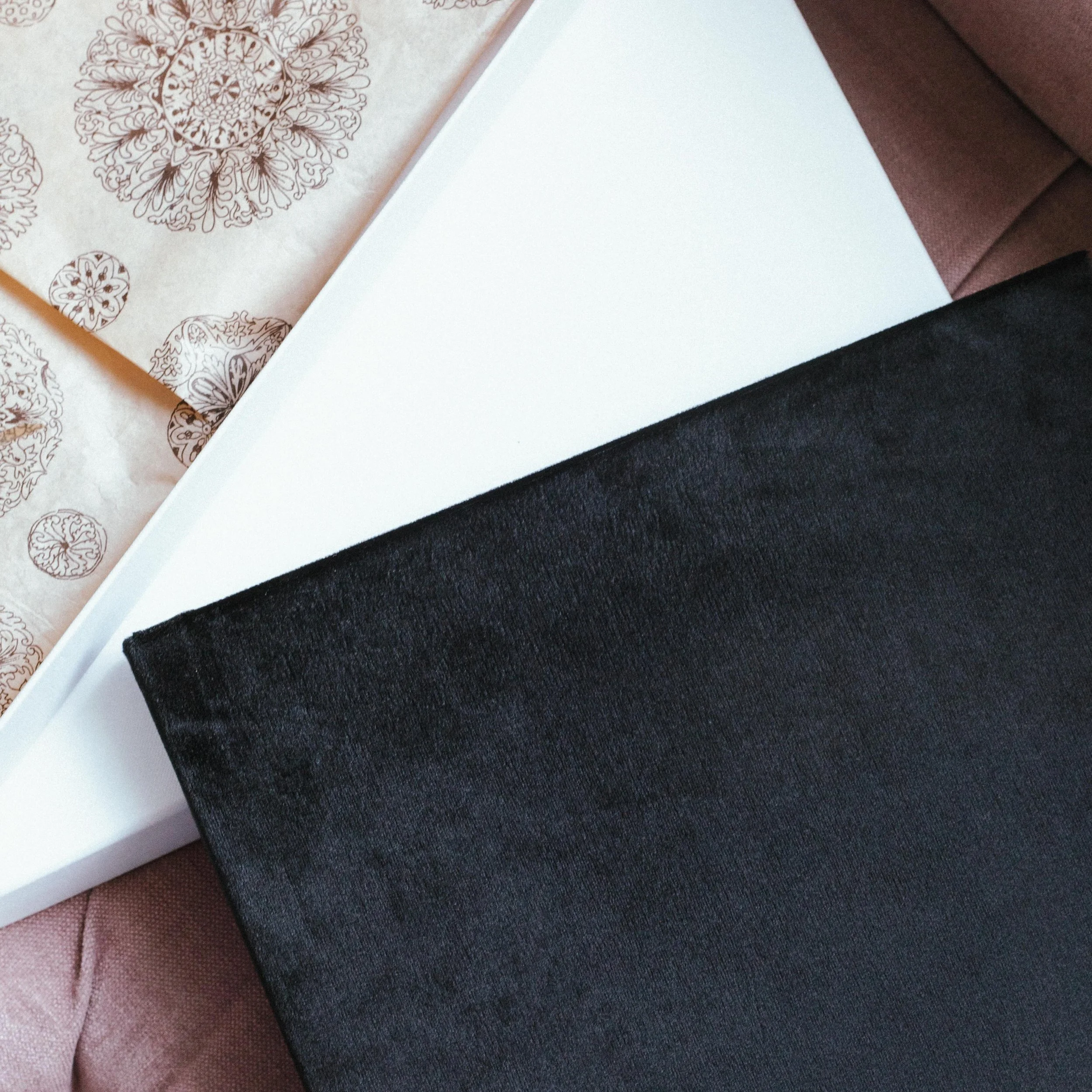 Our luxury handcrafted boudoir albums are designed as intimate heirloom pieces: discreet, elegant, and deeply personal. Wrapped in french velvet, thoughtfully designed image by image, and presented with white gloves and a custom care card for preserv