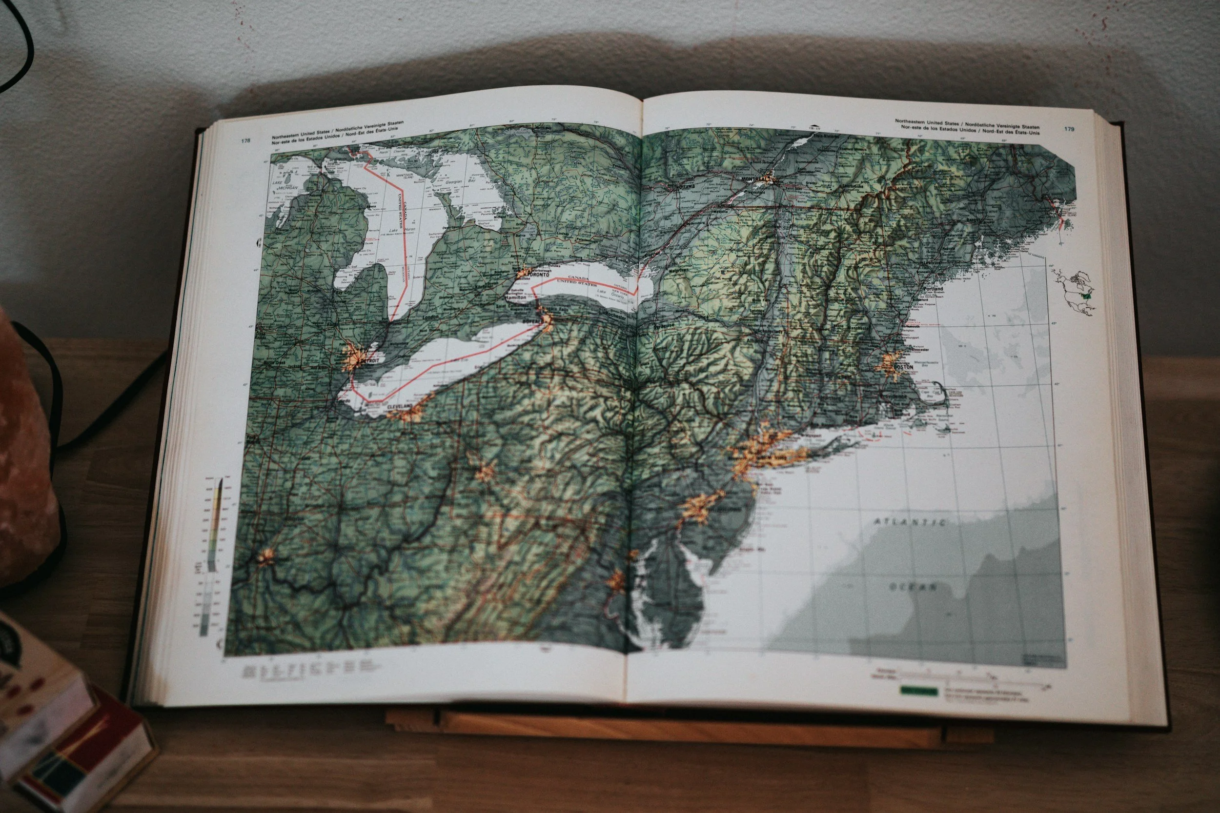 Open map book showing the northeastern United States, including New York, Pennsylvania, and surrounding states.