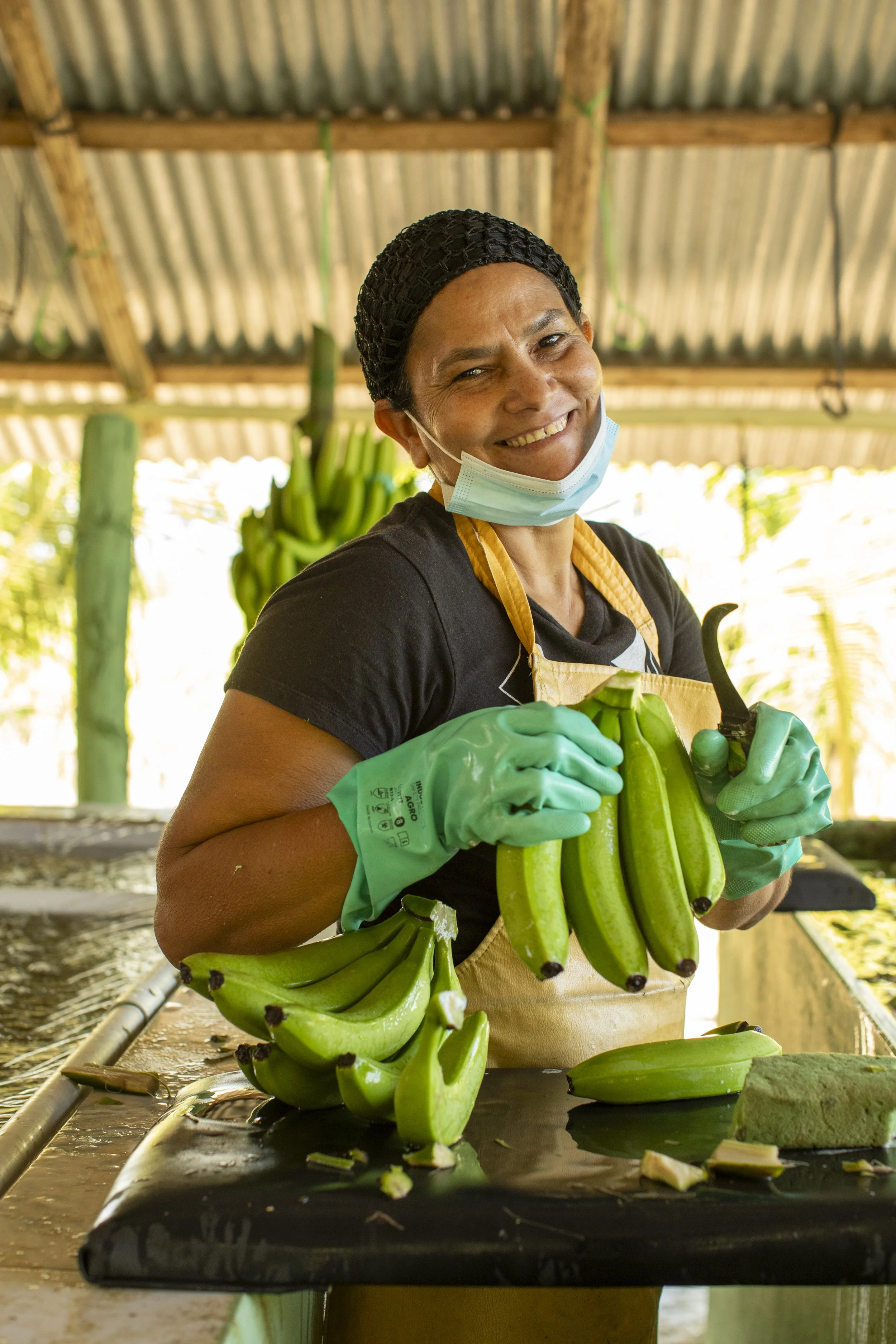 Patria Torres, banana selector, poses for a portrait at a BANELINO farm, Dominican Republic