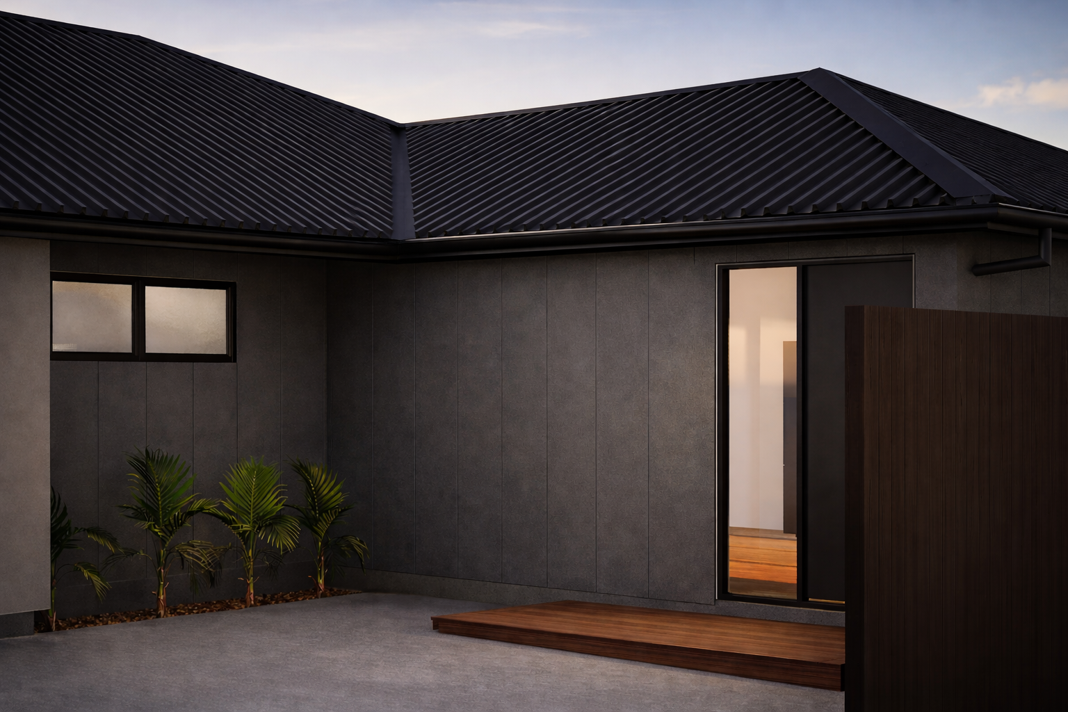 Modern house exterior with dark gray walls, black metal roof, and wooden porch, with a hinged front door and small window, and green plants against the wall.