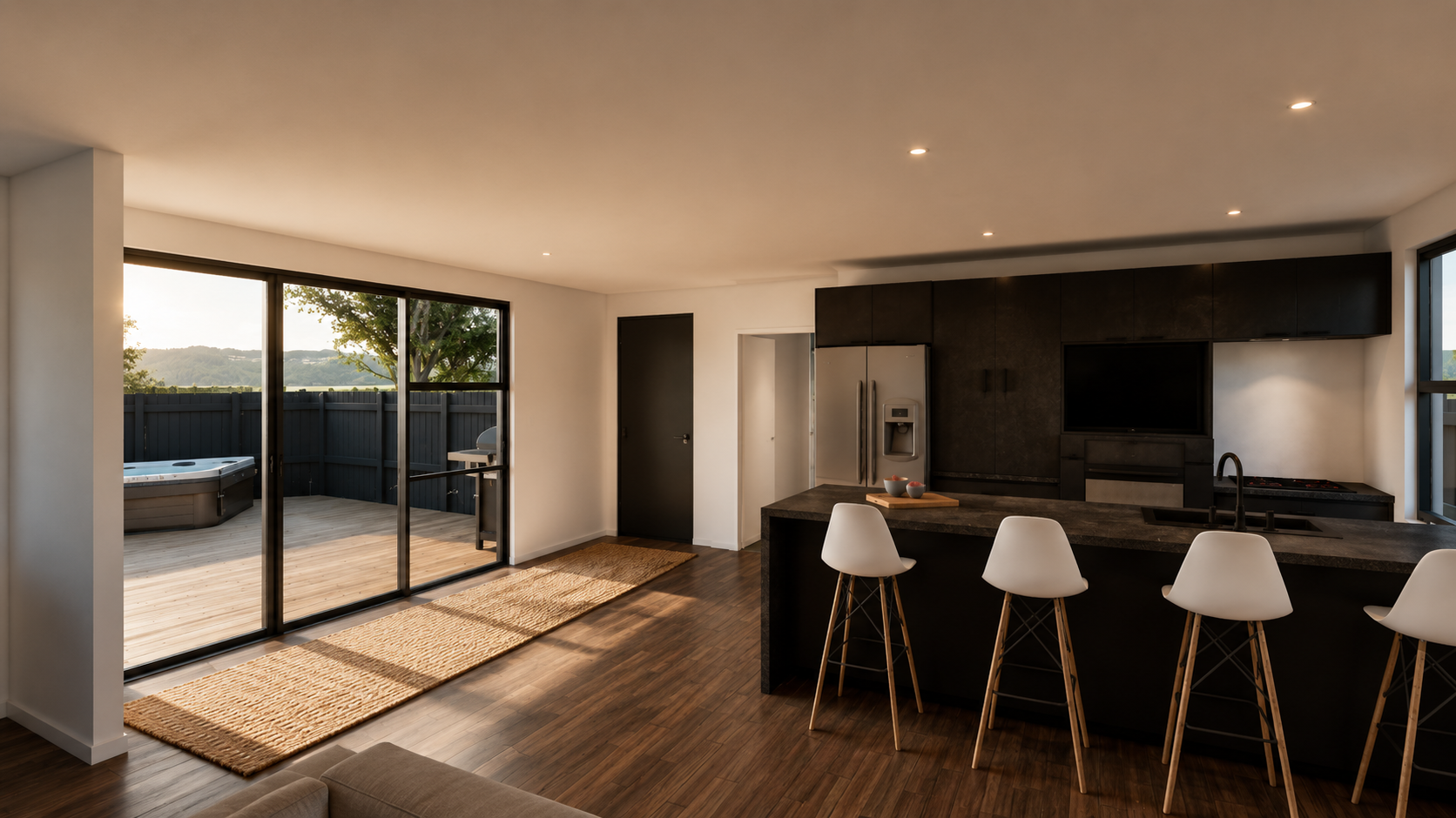 Modern kitchen and living area with large sliding glass doors leading to a deck with a hot tub, view of trees and hills outside.