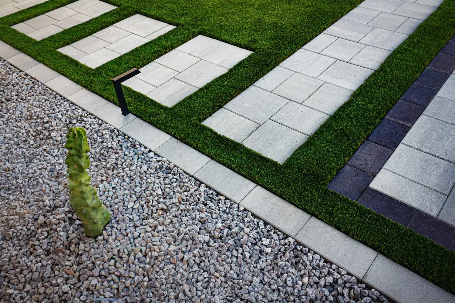 Rising Tide Landscapes hat placed on grass during project work in Scottsdale, AZ featuring plantings