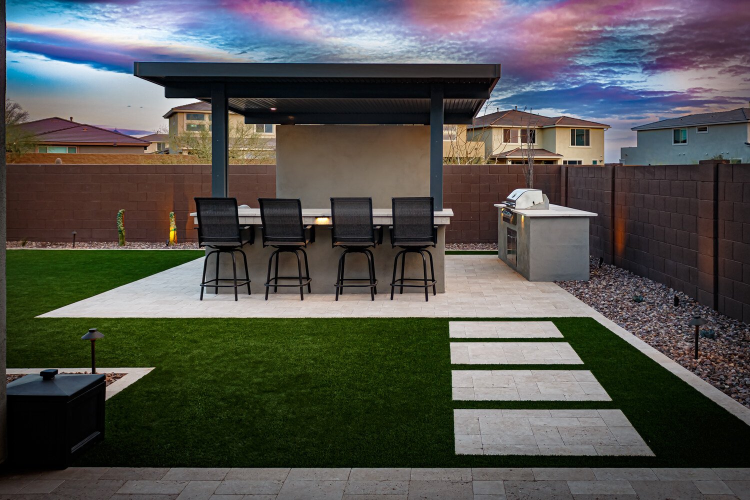 Outdoor kitchen in Queen Creek, AZ connected to the patio with bar seating and pergola shade