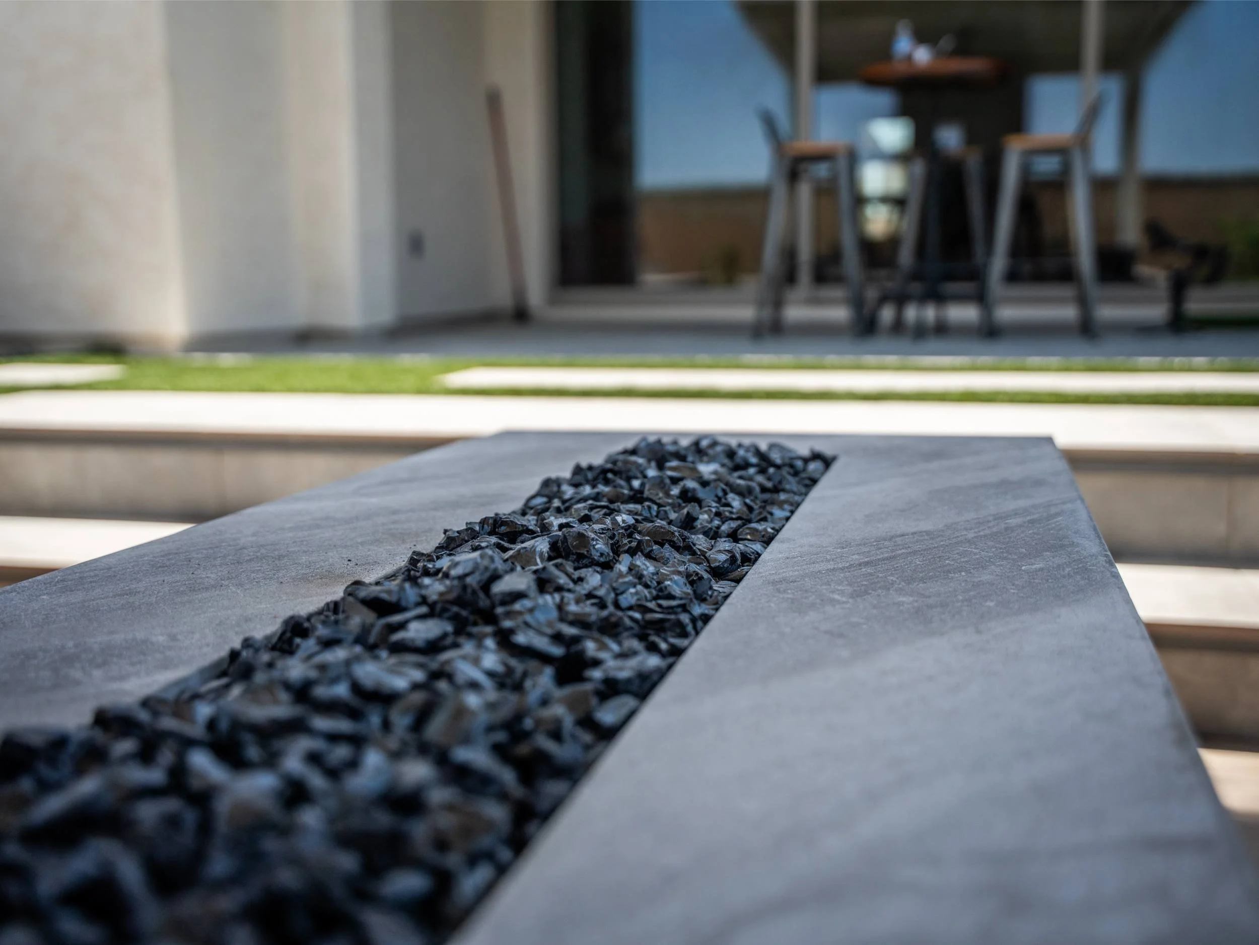 A backyard in Paradise Valley, AZ featuring outdoor fireplace seating and curated plantings