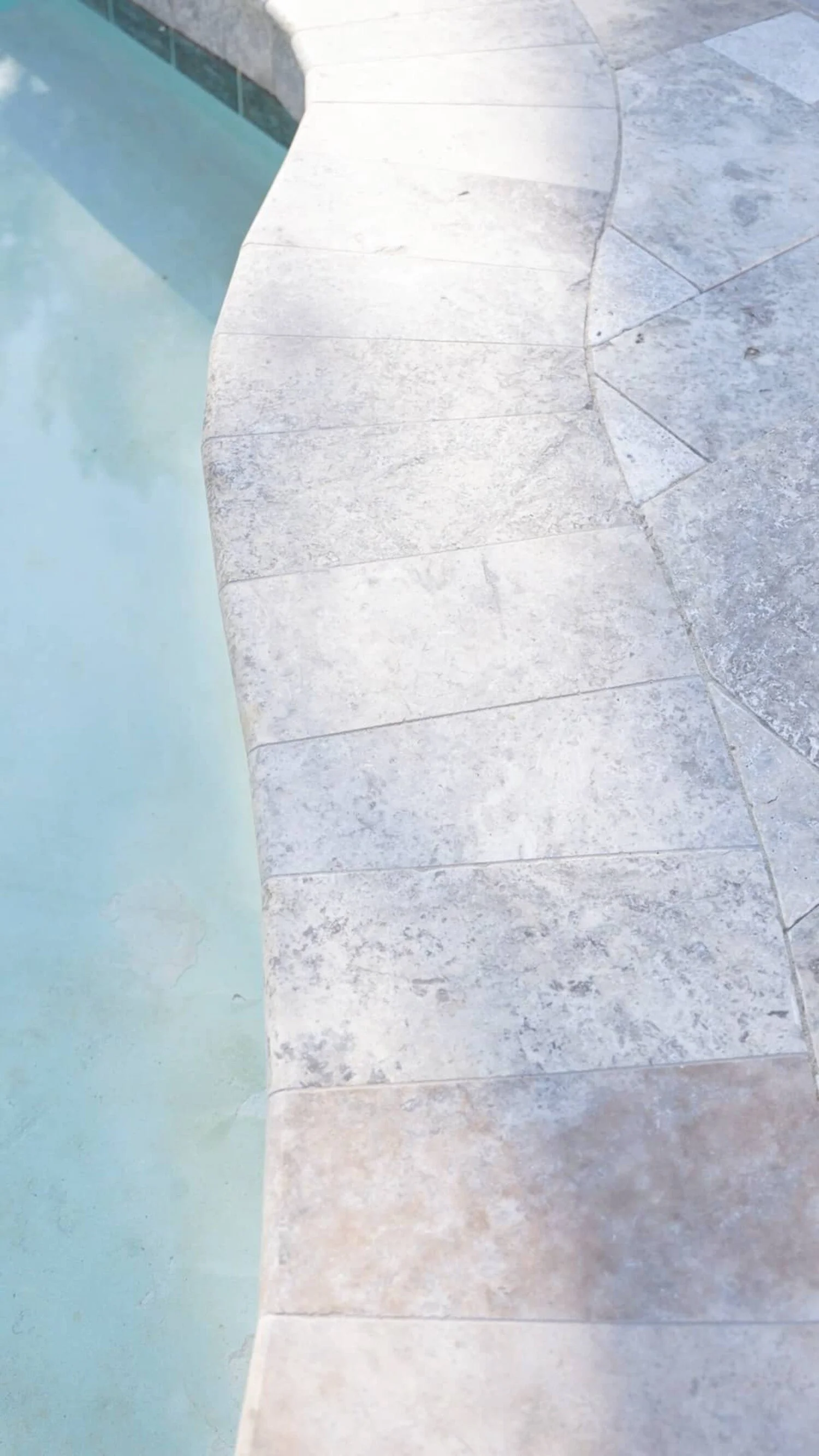 A curved walkway in Surprise, AZ showing textured pavers with soft neutral tones